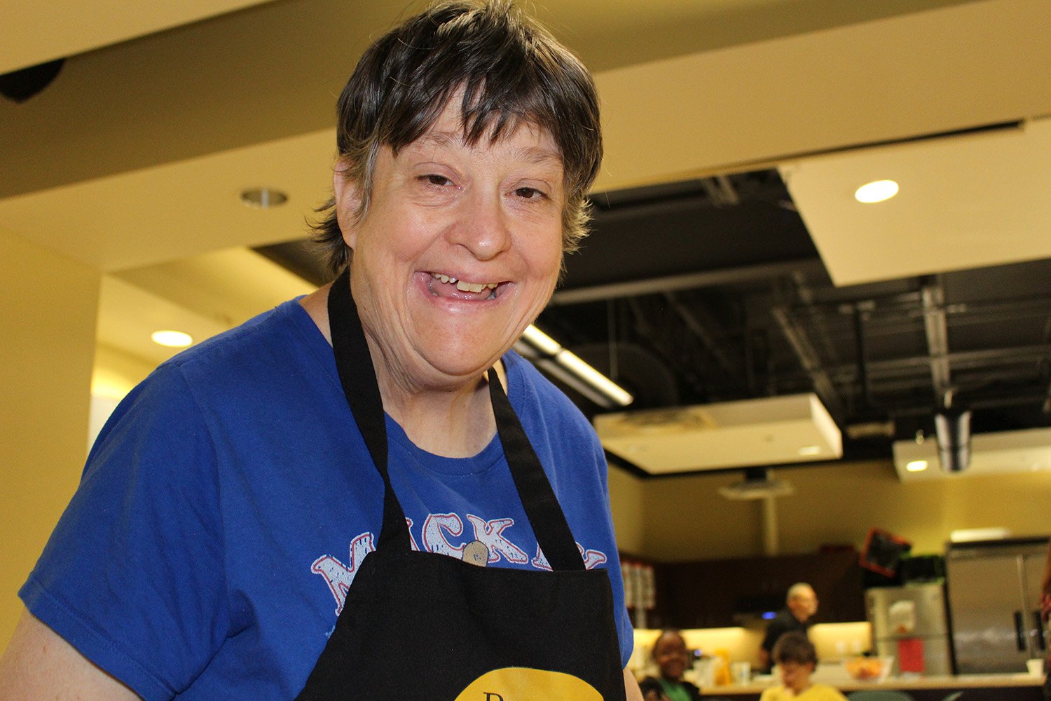 Developmentally disabled women smiling while working at Beehive Cafe