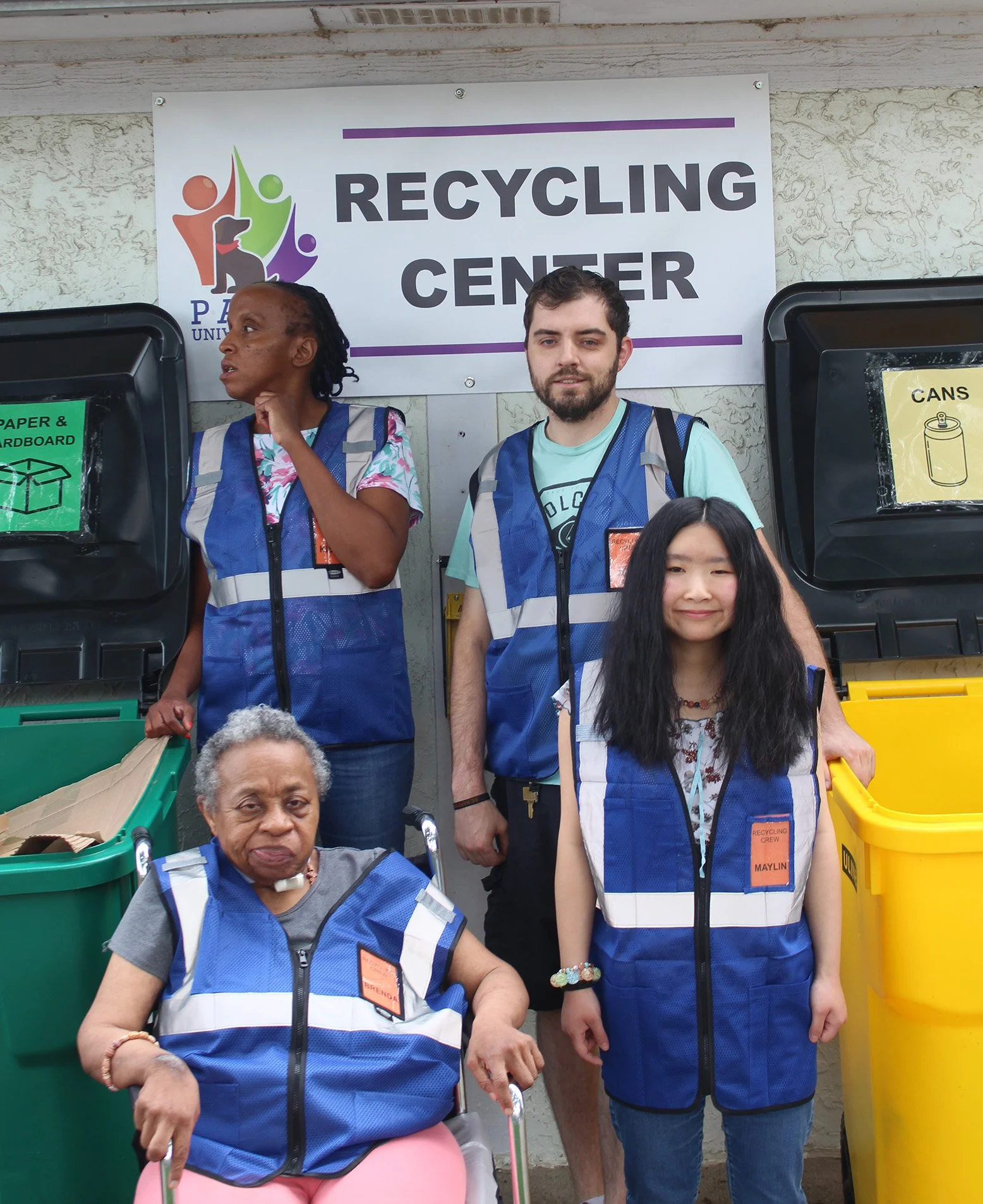 Group of people working at recycling center