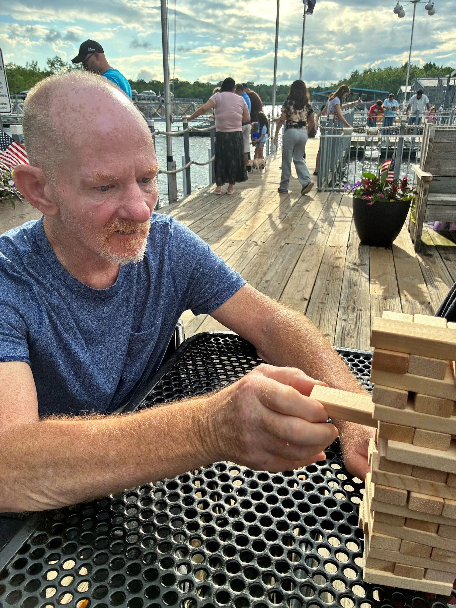 Adult playing jenga on a pier