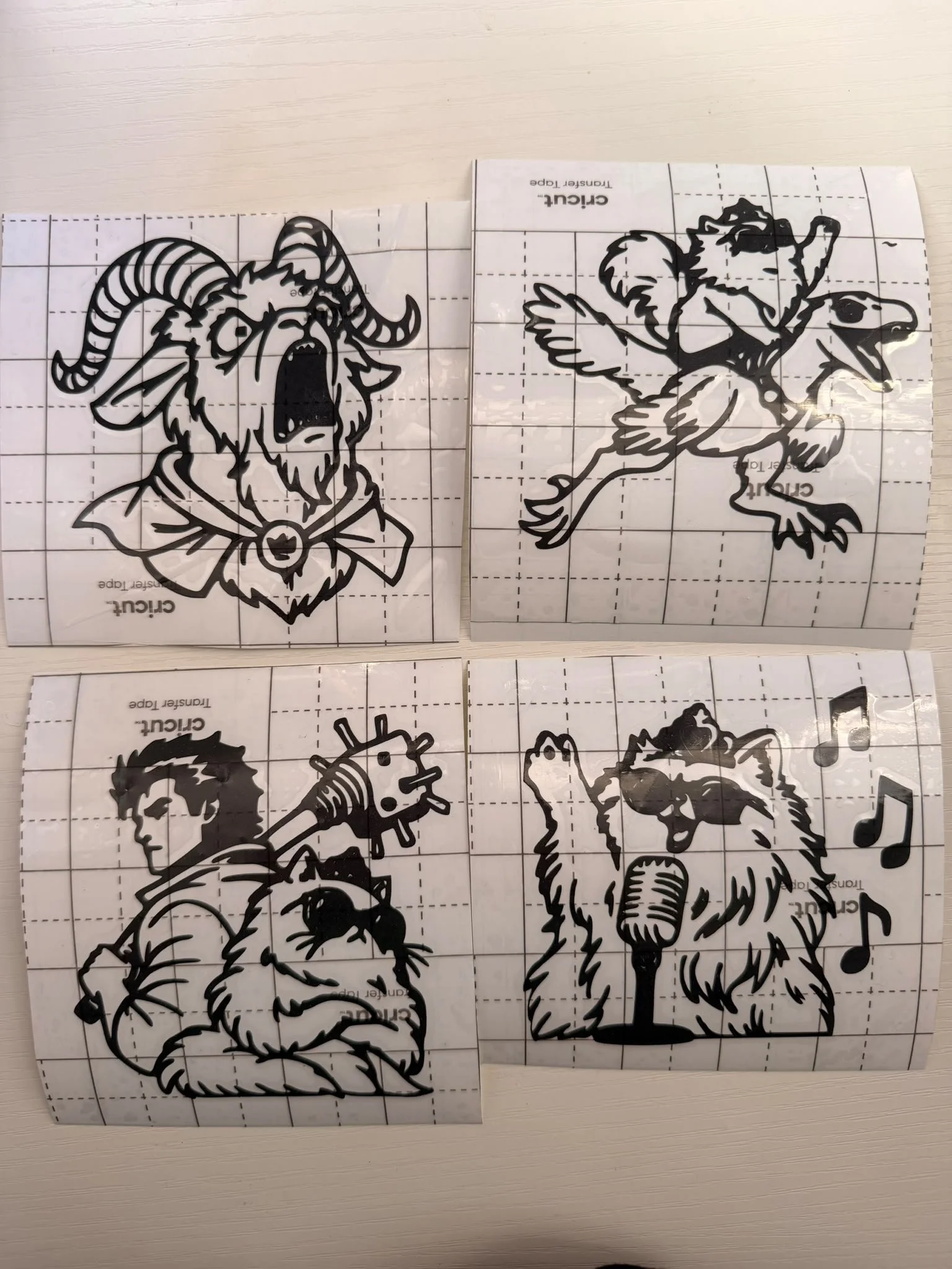 Line art stickers of a goat with curved horns and a beard, a bird with a microphone, and a wolf howling at a musical note on a grid background.