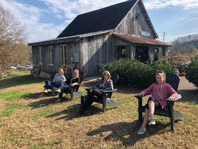 Visitors relaxing outside a rustic shop in Leipers Fork, Franklin, Tennessee