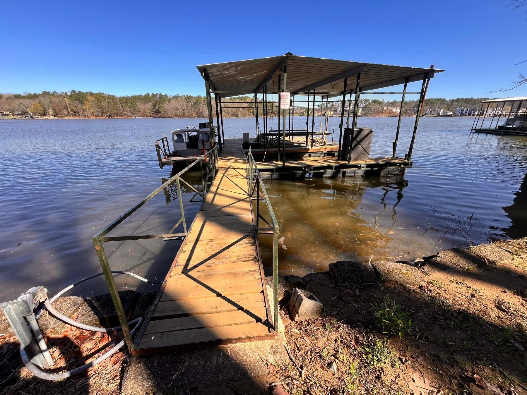 Shallow water under a dock walkway at low lake level before the spring refill