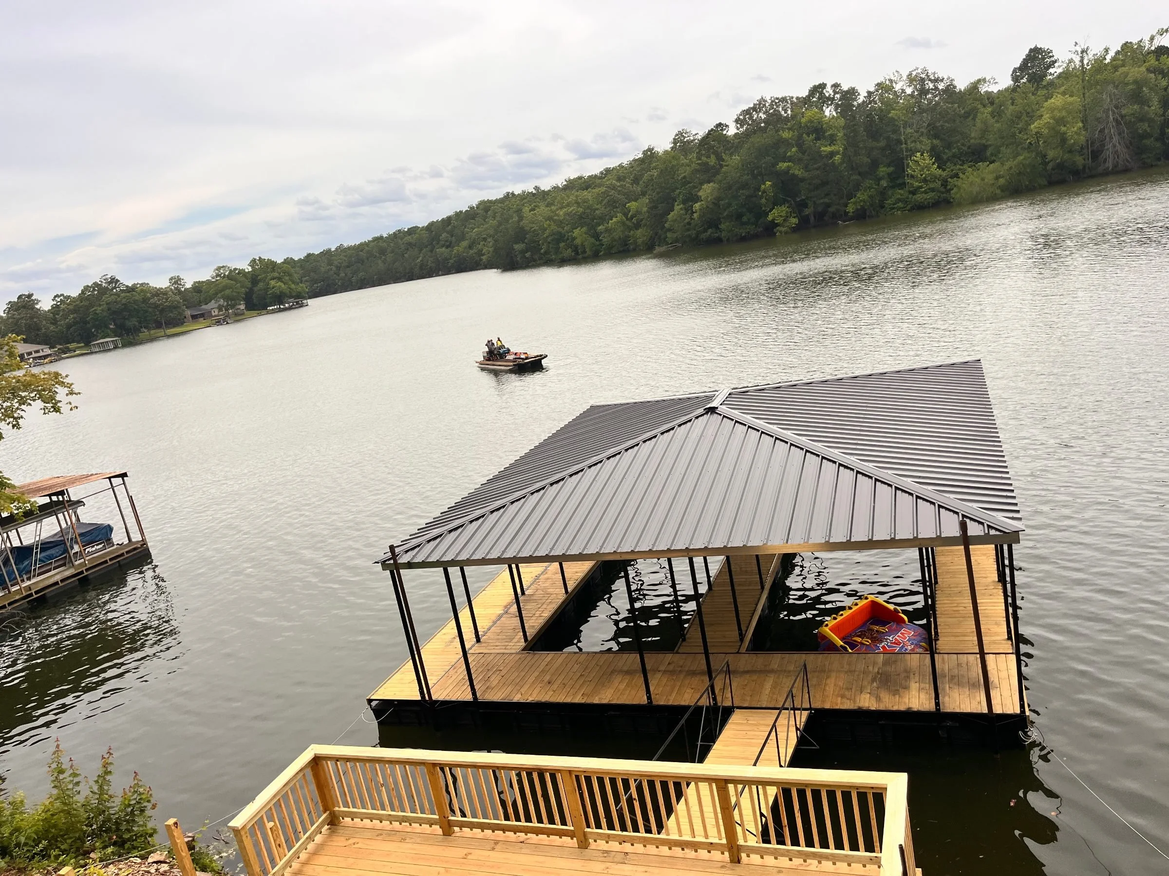 Hip-roof floating boat dock with walkway, built by Williamson Boat Docks on Lake Hamilton