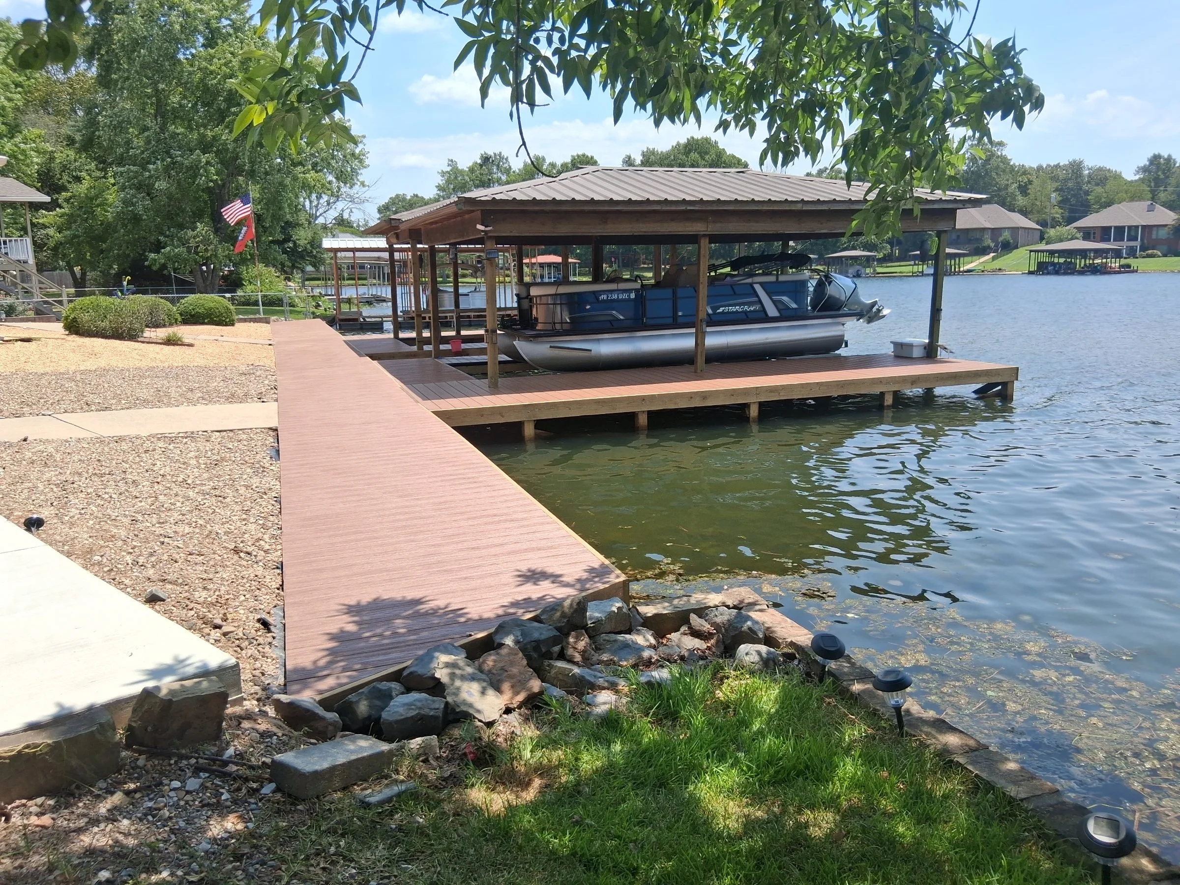Paver walkway leading to a covered boat dock on Lake Hamilton, built by Williamson Boat Docks