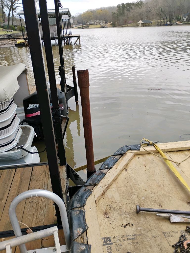 Repositioning an anchor pipe from the work barge during a drawdown dock move