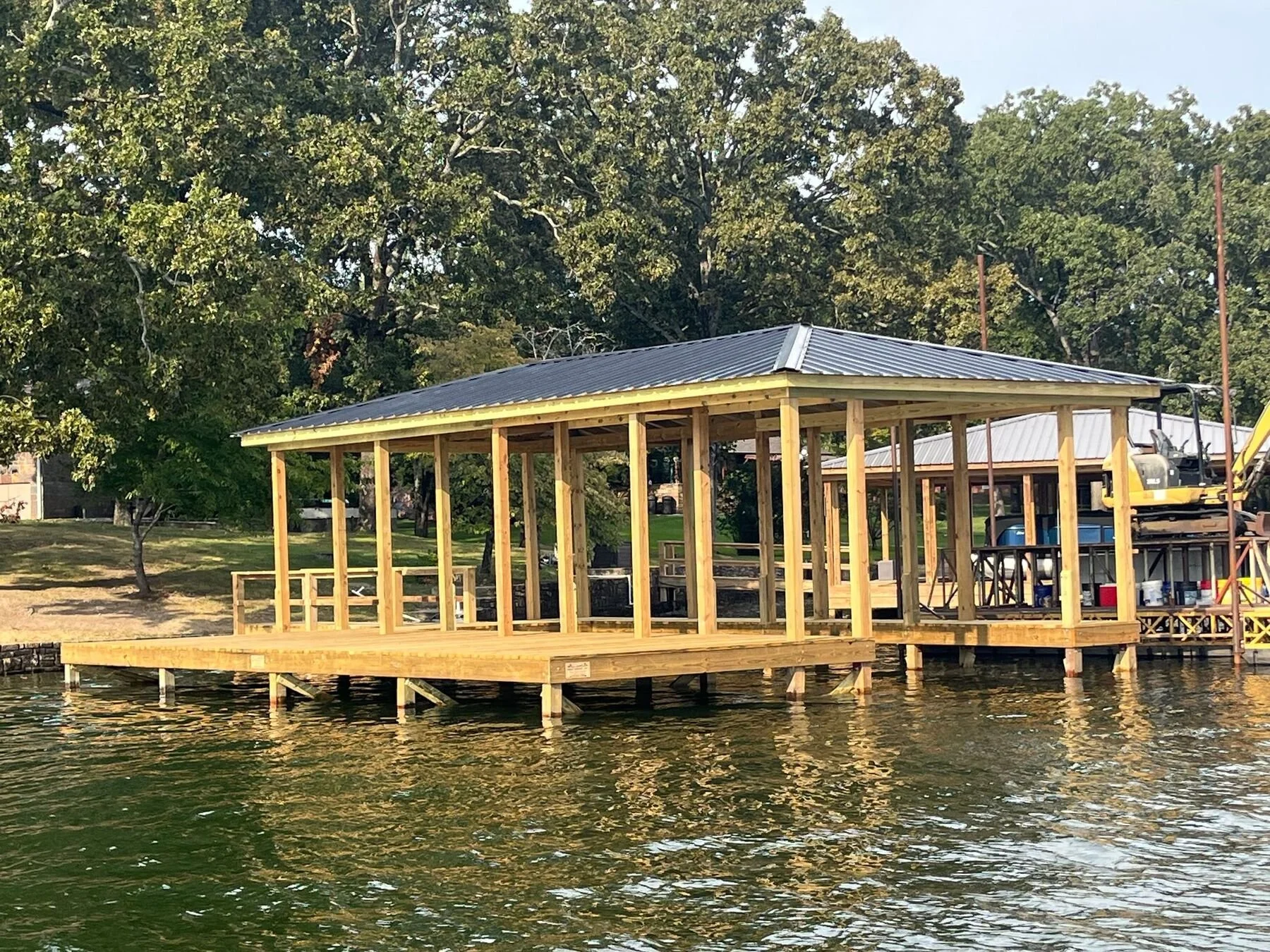 Wide covered boat dock with fresh timber framing, Lake Hamilton