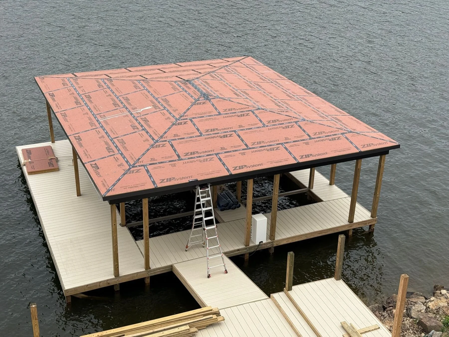 New boat dock with a red metal roof seen from above, Lake Hamilton