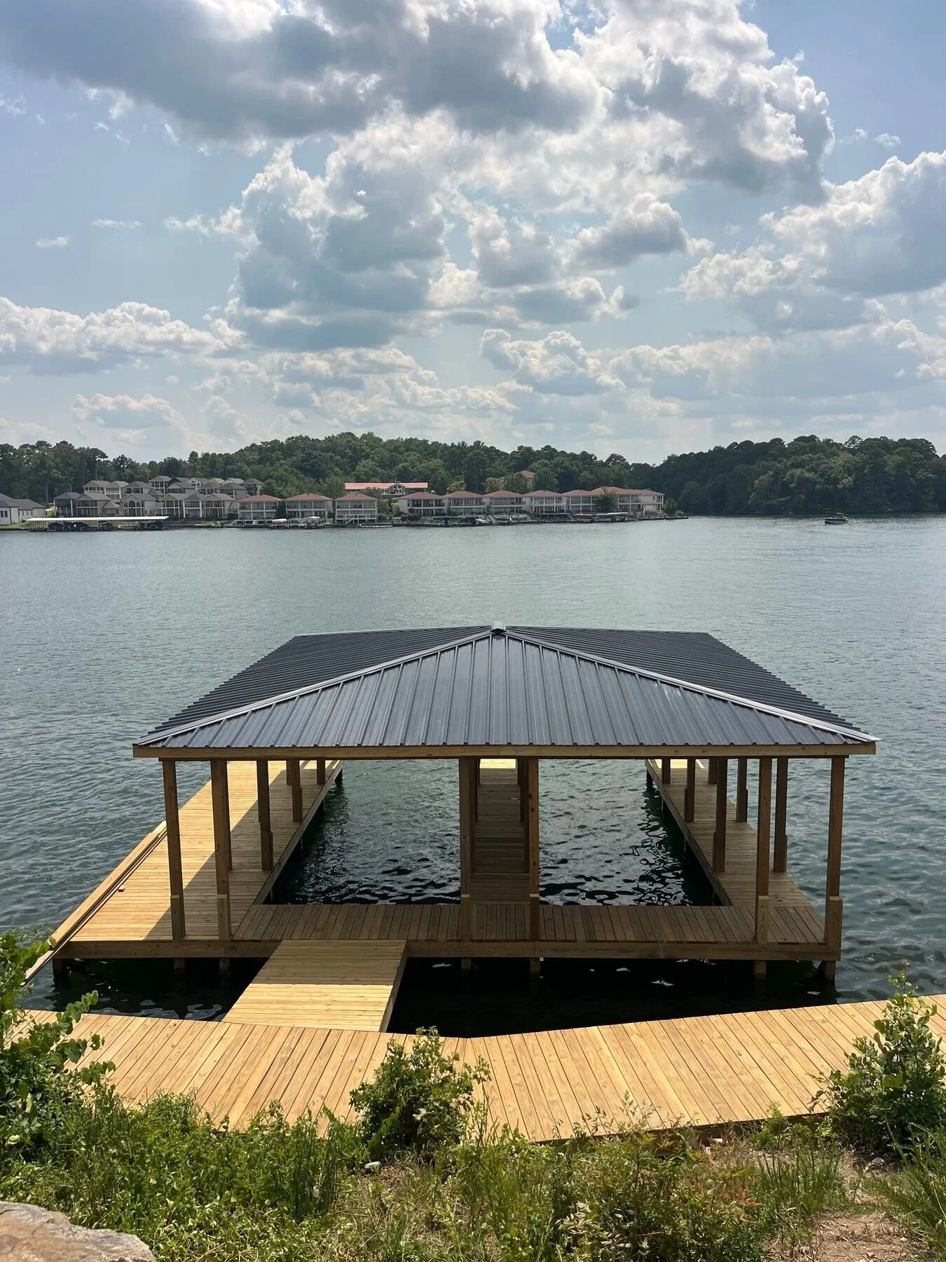 Covered stationary boat dock with a metal roof, Lake Hamilton