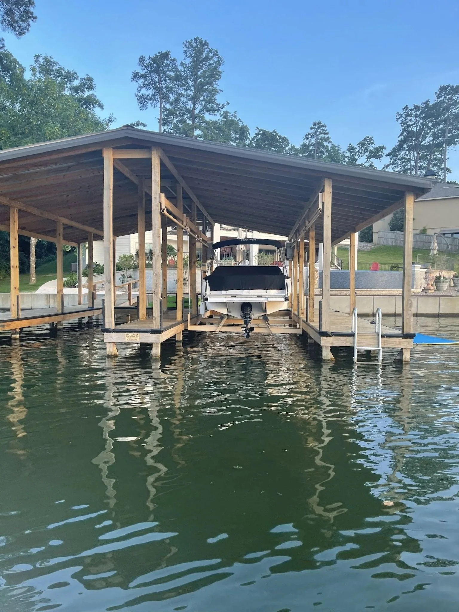 Covered stationary boat dock with pontoon on Lake Hamilton
