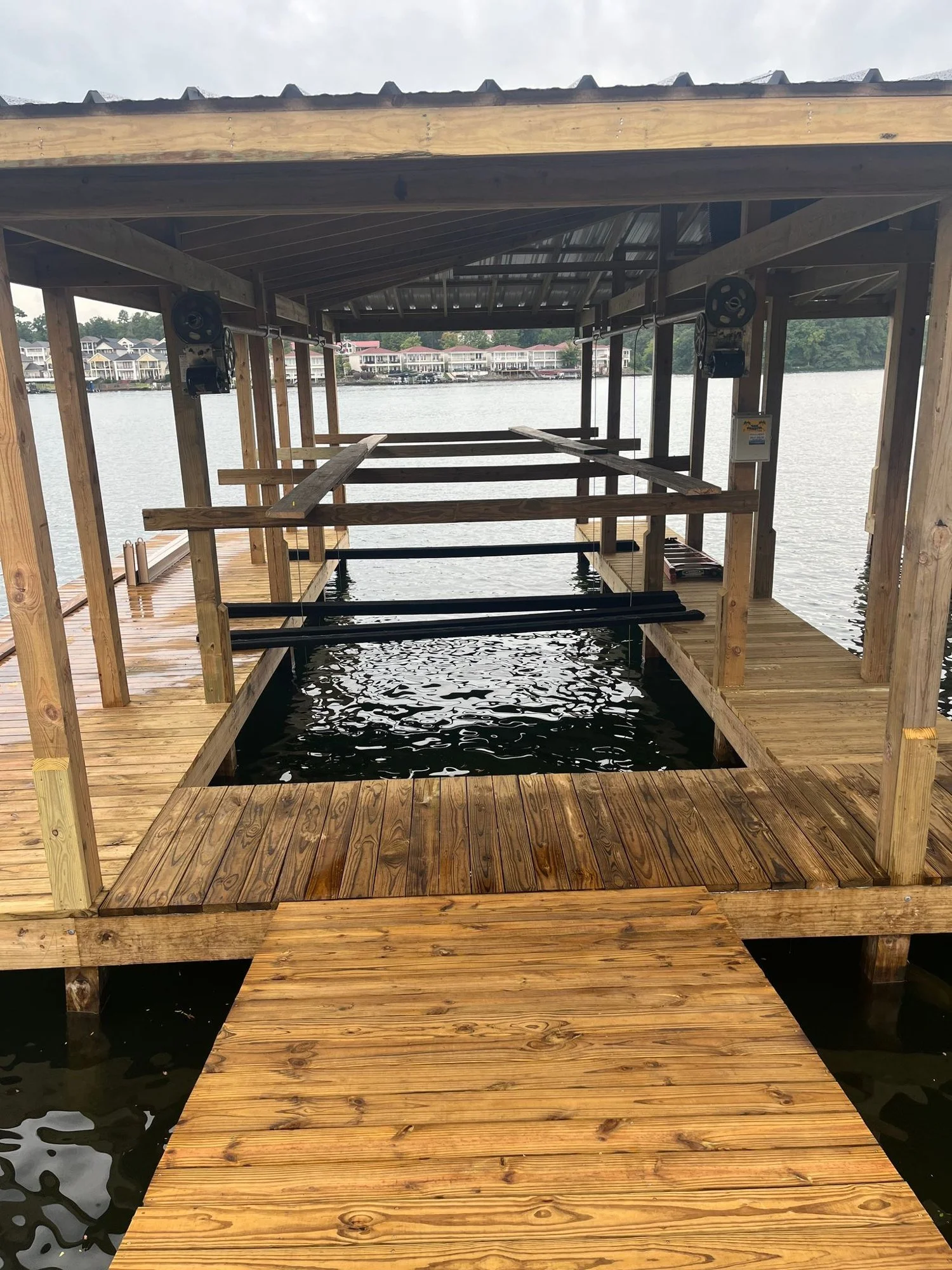Inside a newly built boat dock showing fresh treated lumber and framing