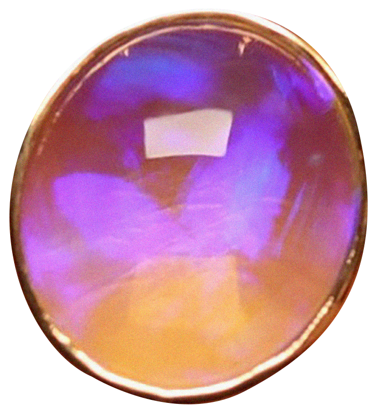 Close-up of a shiny, iridescent sphere with purple, blue, and peach hues reflecting light.