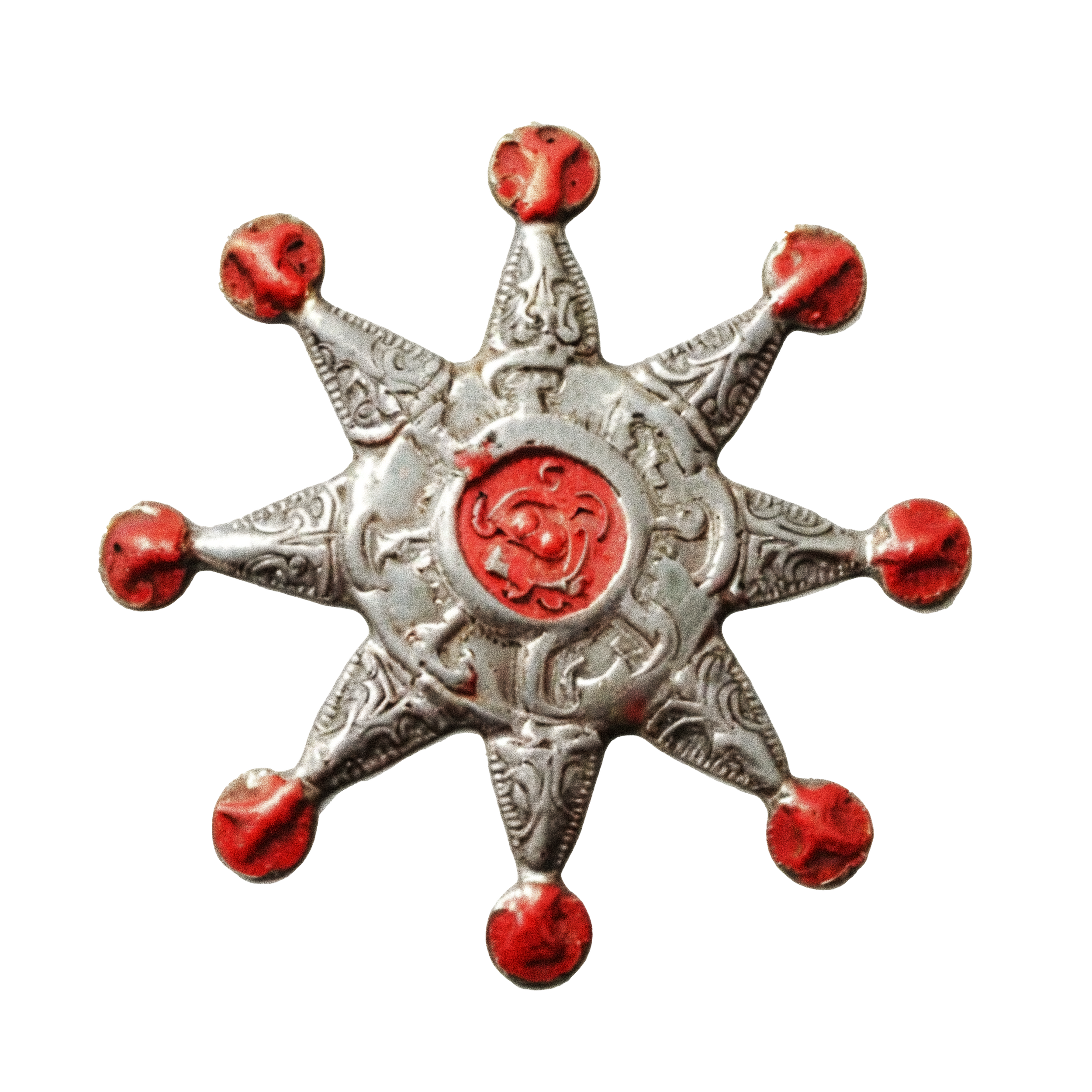 Decorative metal star with red circular accents at each point and in the center, featuring intricate engraved patterns.