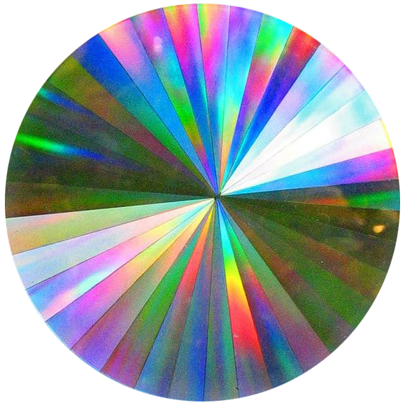 A circular gemstone with reflective, rainbow-like hues and light reflections.