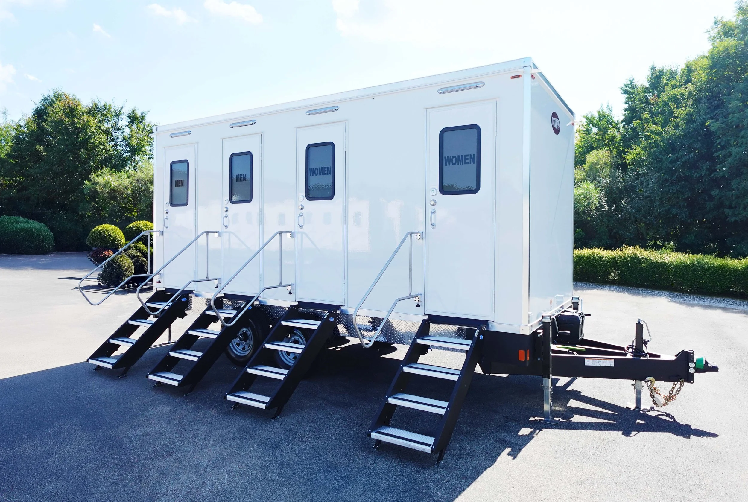 A white portable restroom trailer from Lucky’s Lavish Lavatories in Pittsburgh, PA