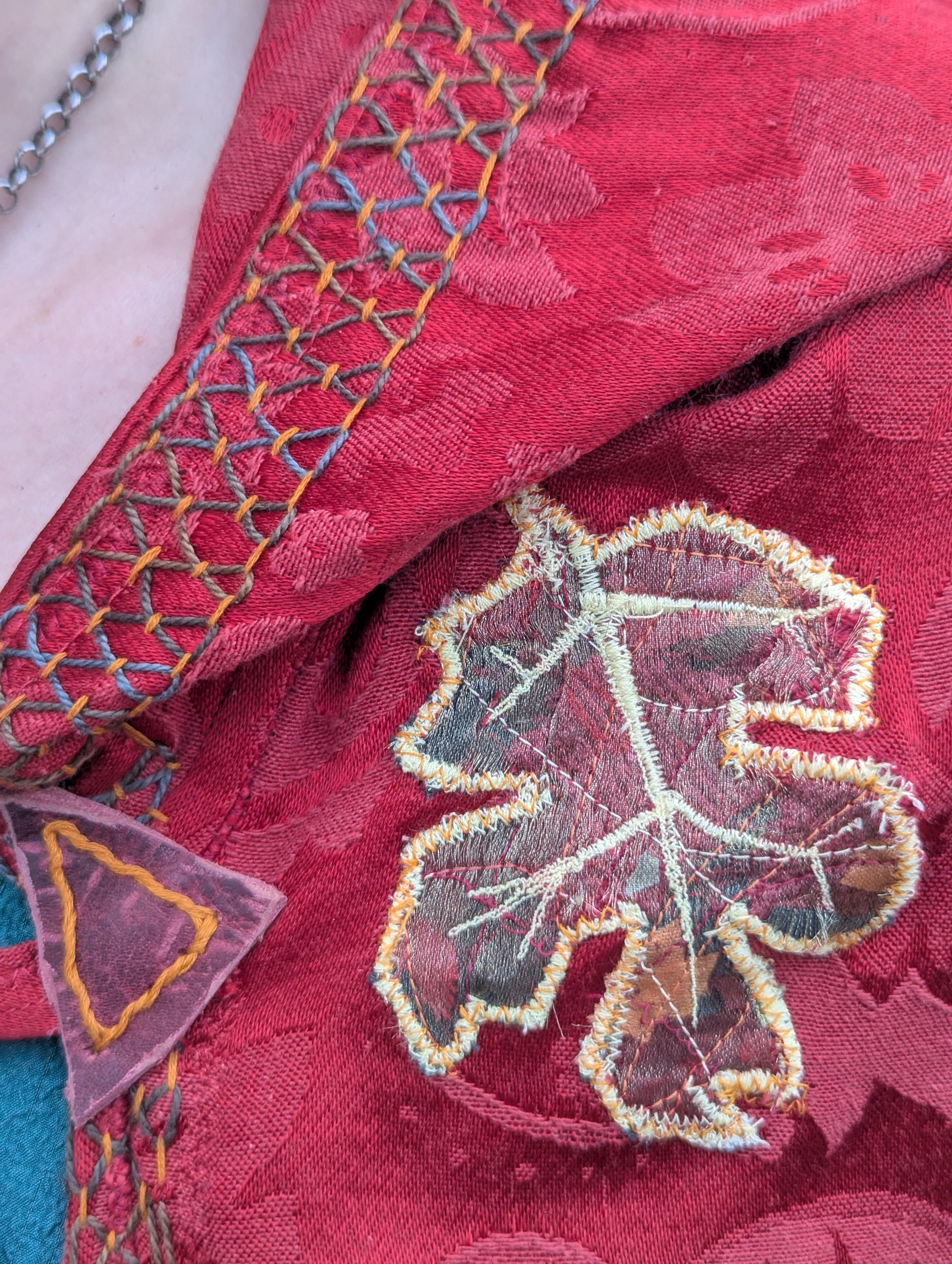 Hand embroidered trim and leaf applique. Leaves are made from scrap fabric using the "crumb" sewing method.