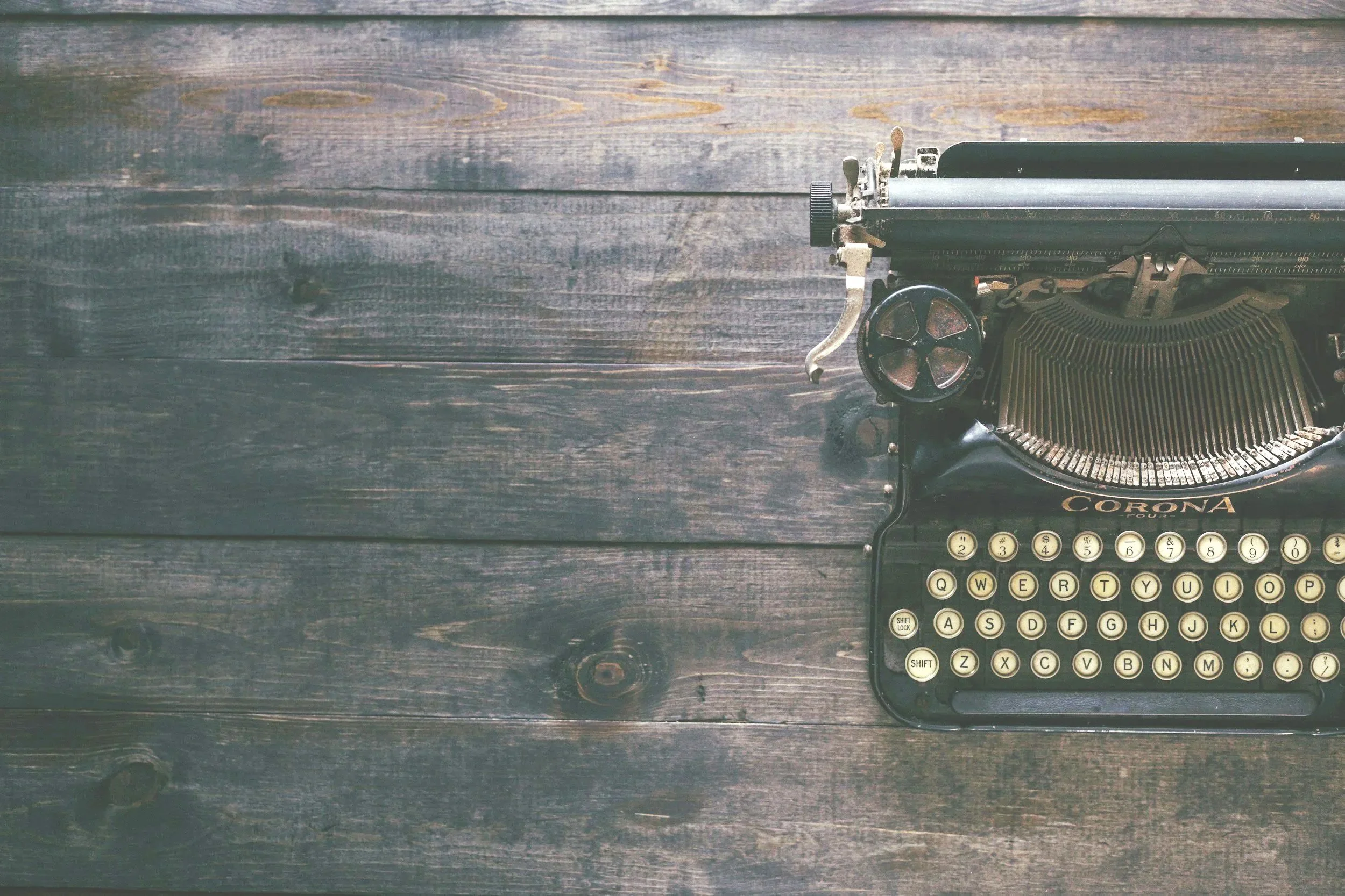 Vintage typewriter on a wooden surface.
