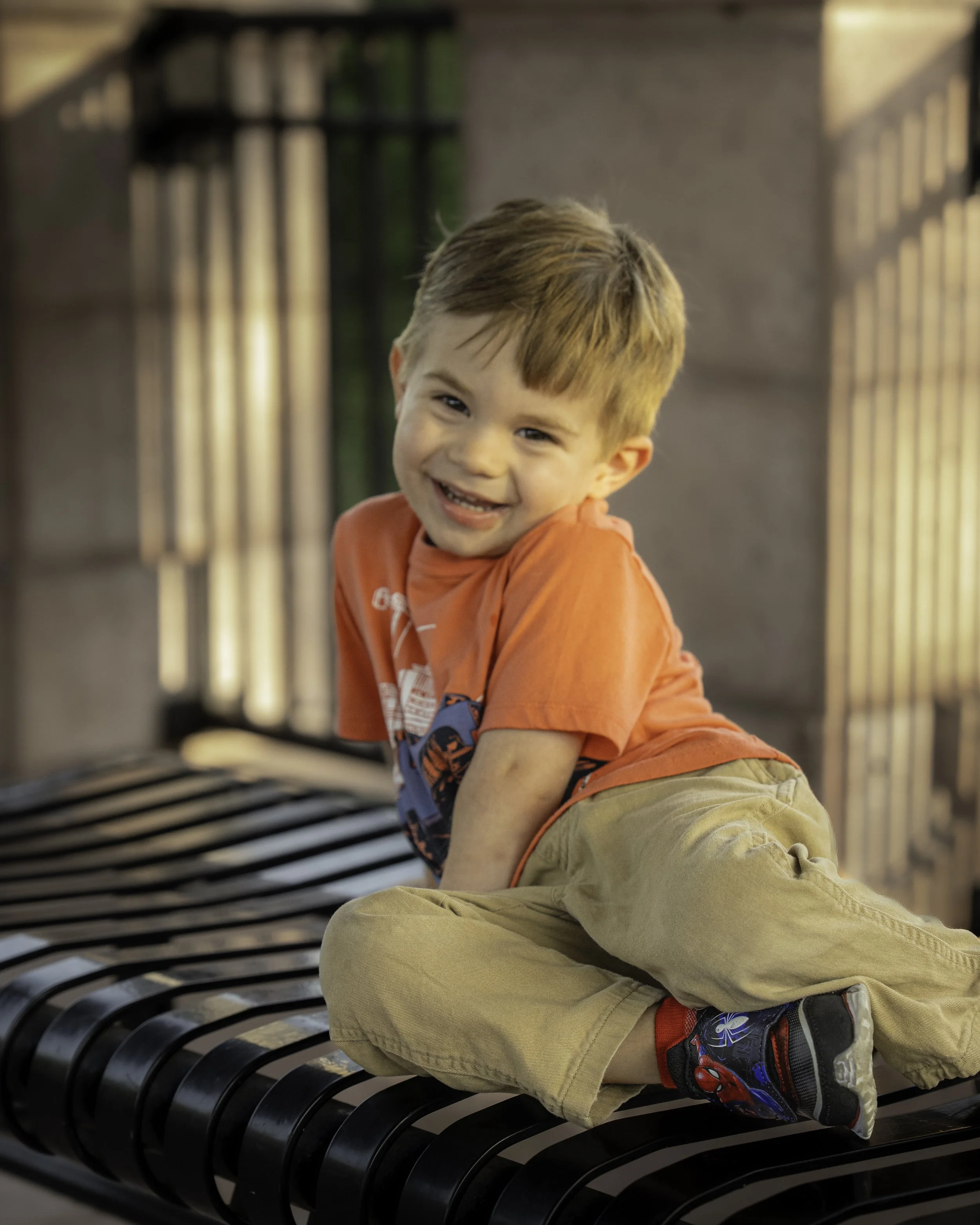 Child smiling on a bench. Florida Botanical Gardens, Largo, Florida.