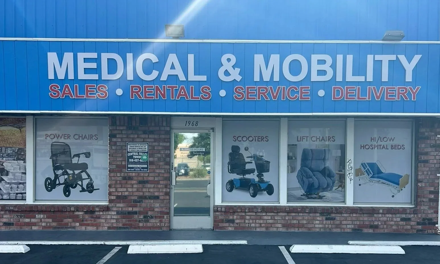 Storefront sign reading 'Medical & Mobility' with services listed below: sales, rentals, service, delivery. Windows display images of power chairs, scooters, lift chairs, hospital beds, and the store address 1968.