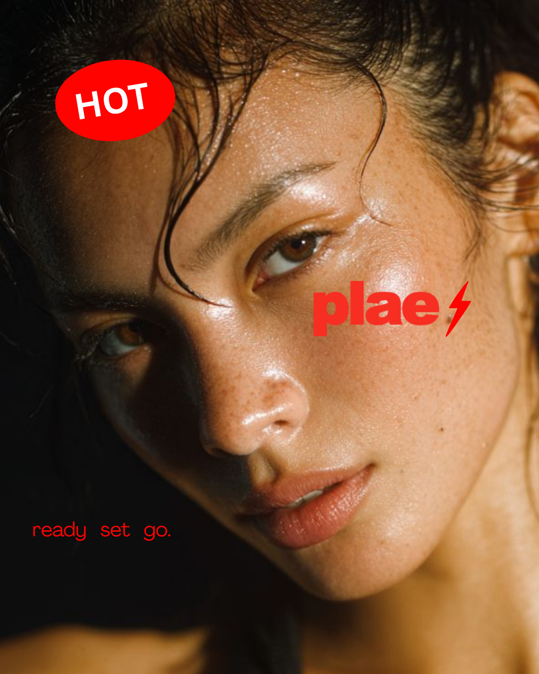 Close-up of a woman's face with wet hair and glowing skin, with red text overlay reading 'HOT', 'plae', and 'ready set go'.