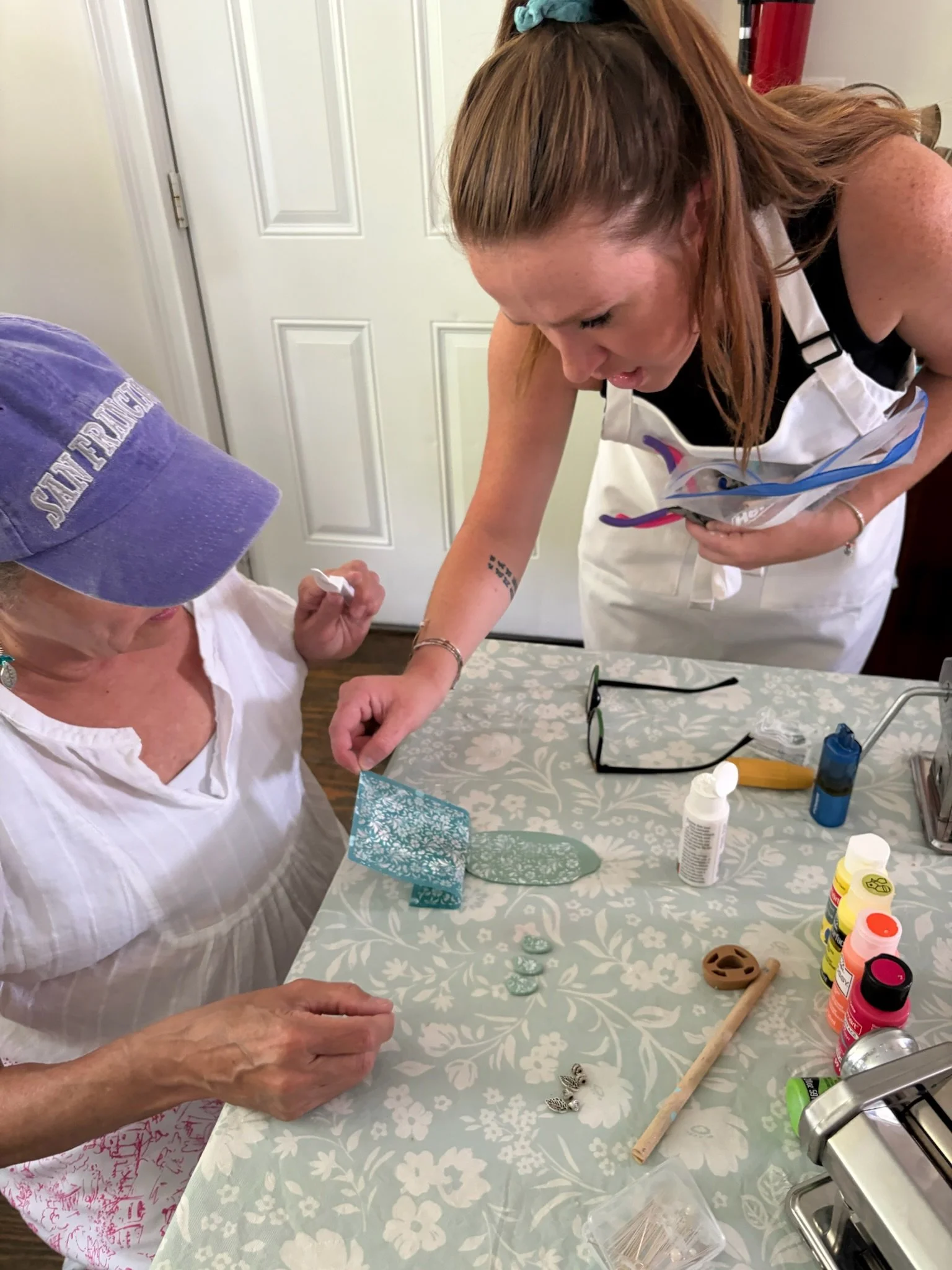 Reagan of Clay By Reagon offering guidance to a guest