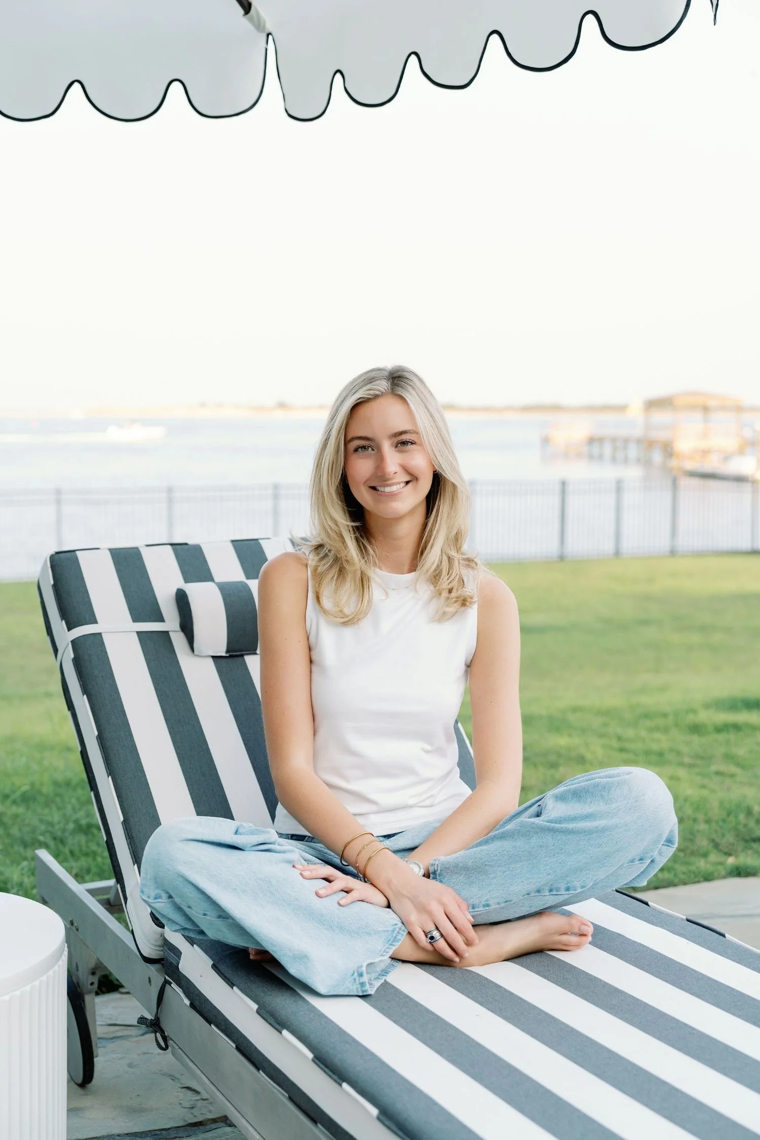 Woman sitting on a striped beach chair
