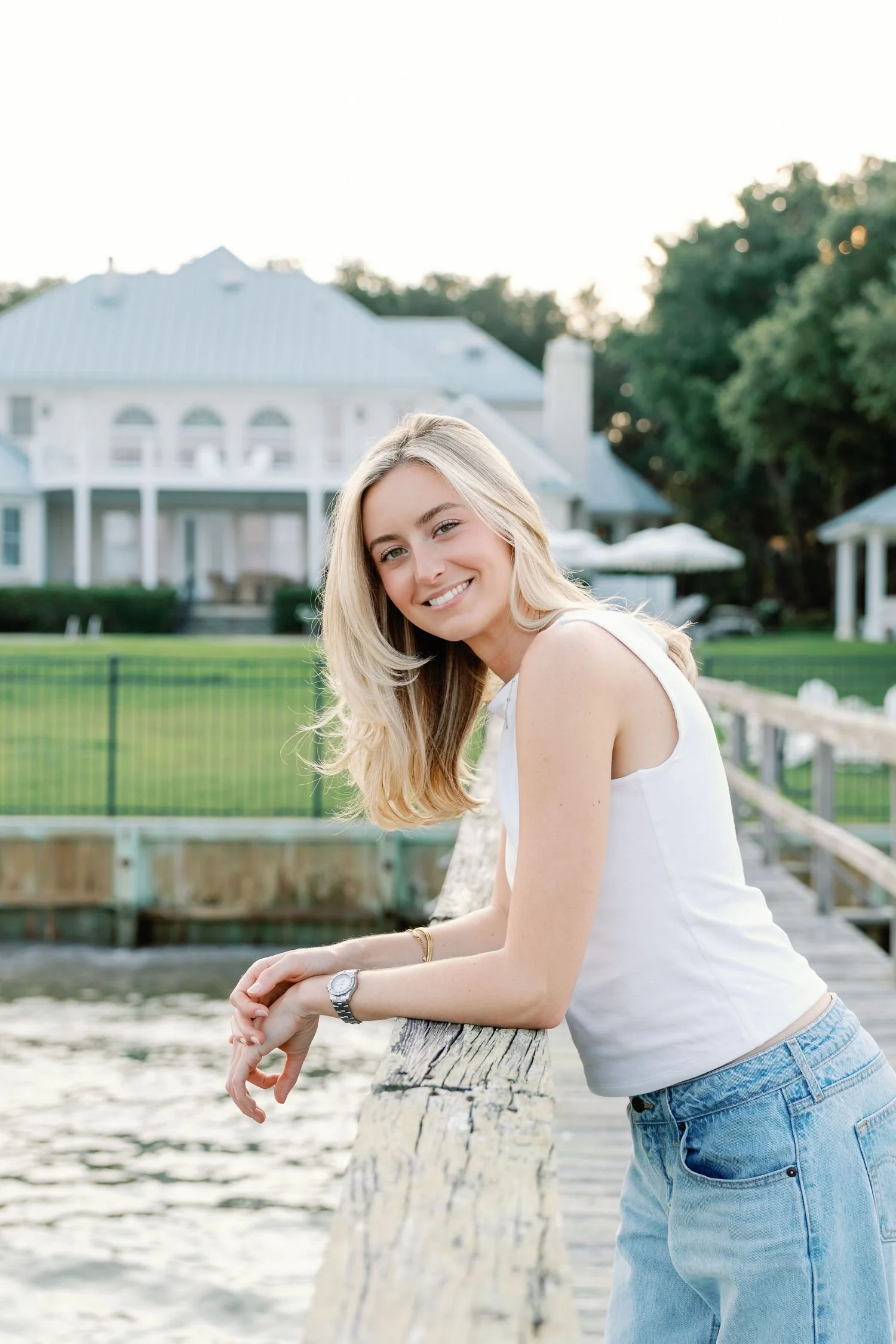Woman smiling and leaning over a dock