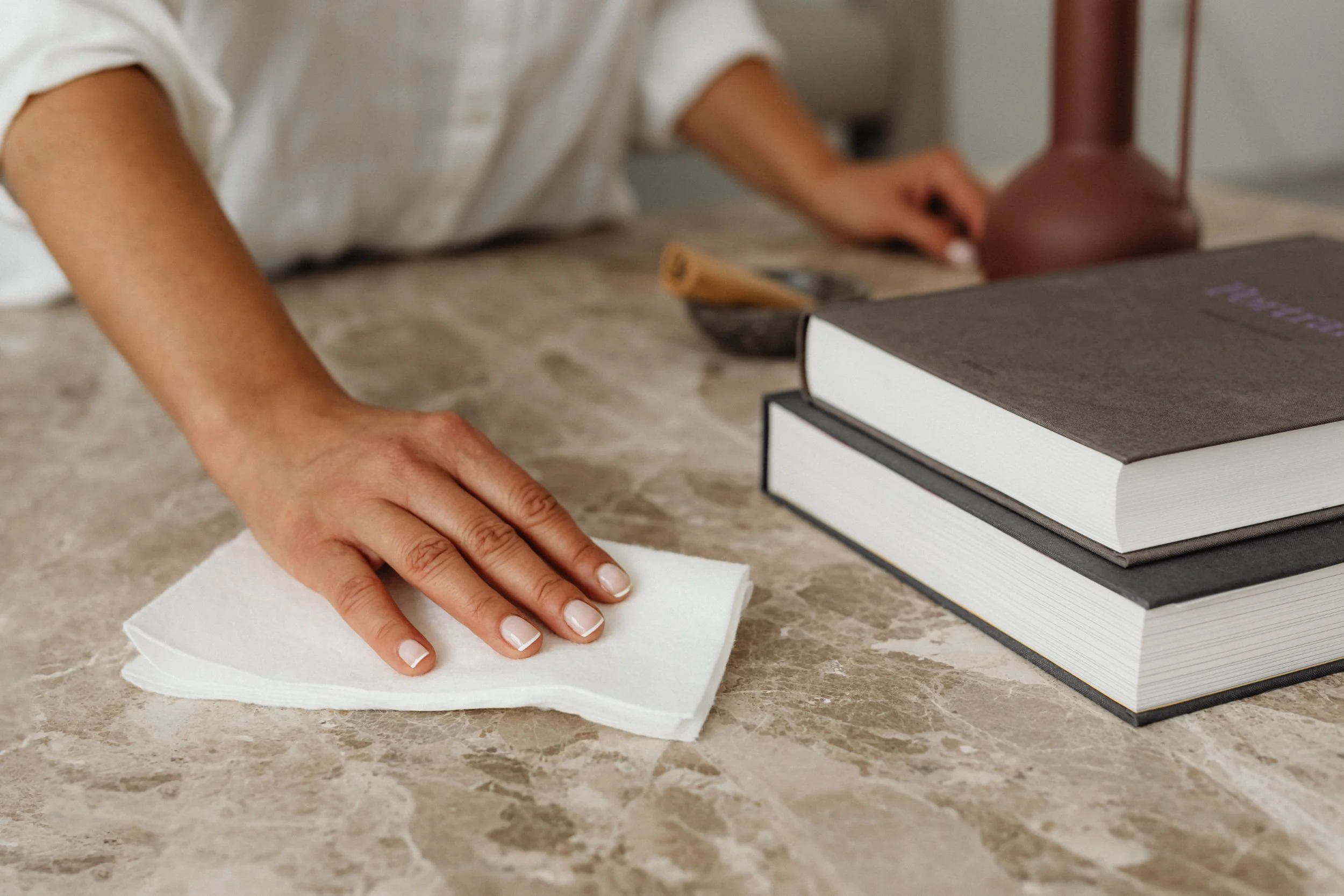 Hand wiping a marble table