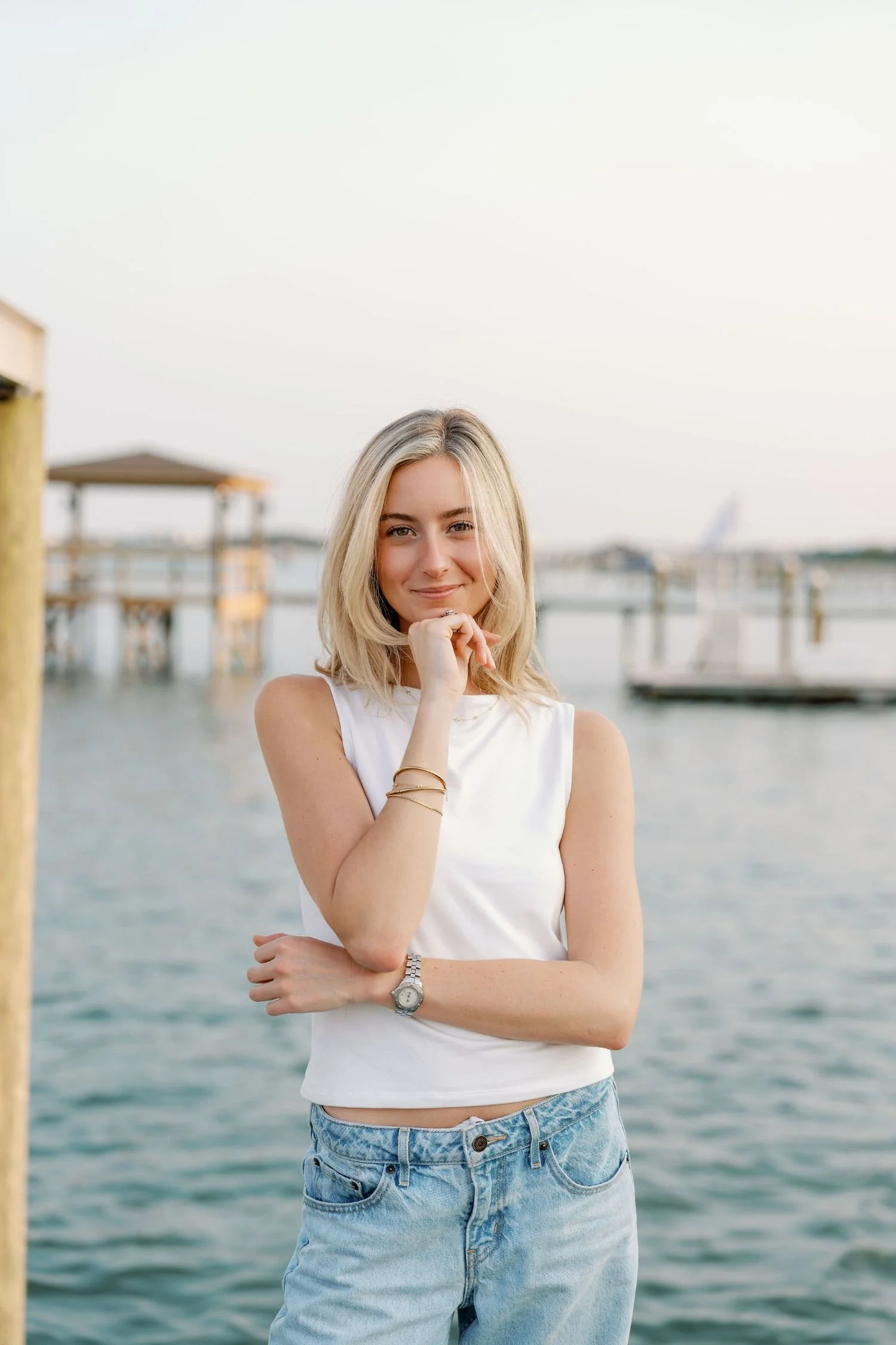 Woman smiling at the camera in front of the ocean