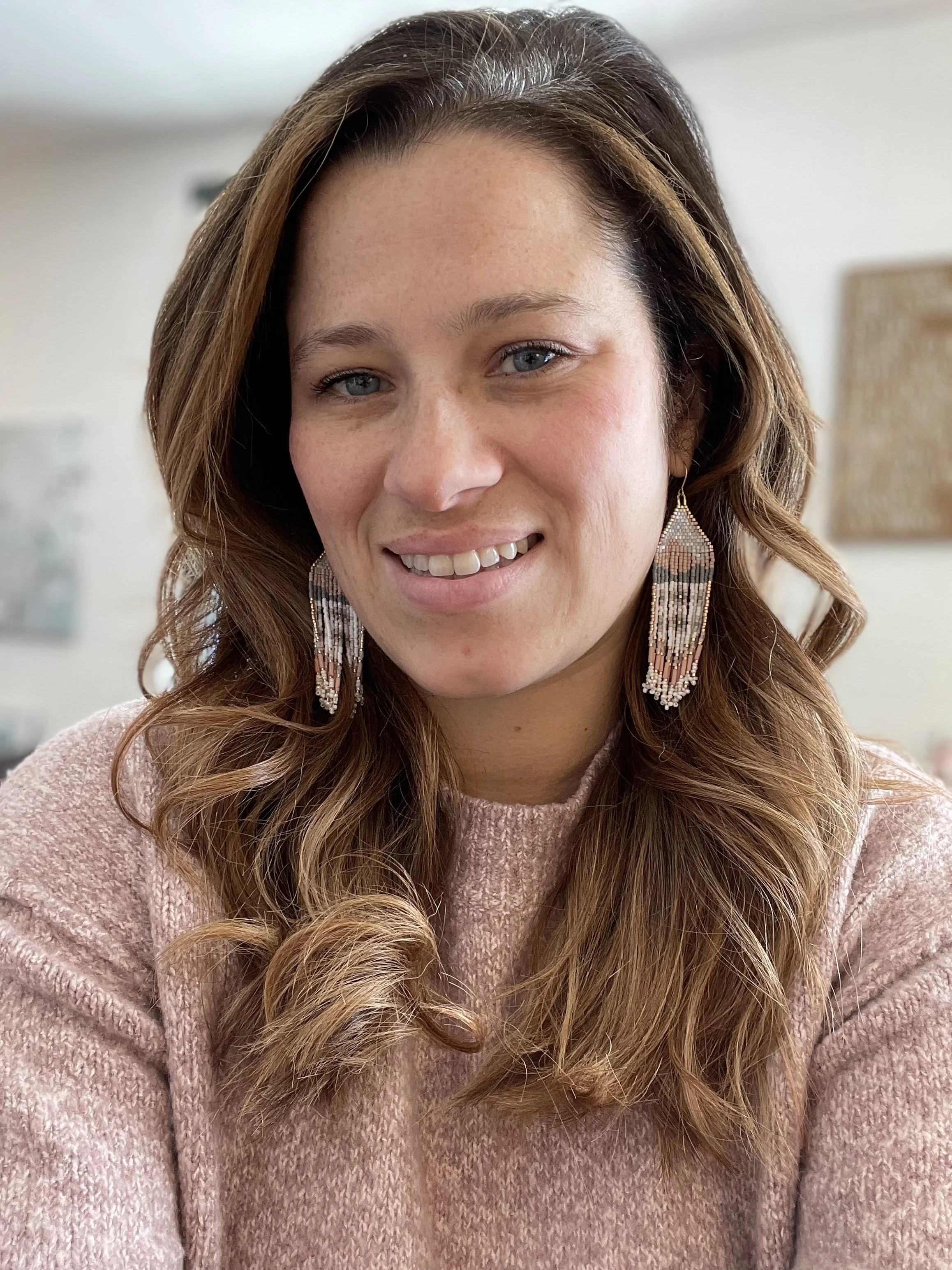 Registered Psychotherapist at Trent River Wellness in Norwood, Ontario. Headshot portrait of a smiling female therapist in a warm, welcoming office environment.