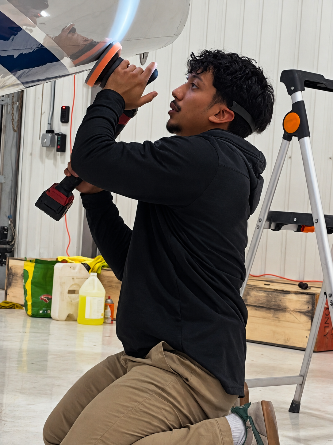 Aircraft technician polishing a private jet exterior in Washington DC, Maryland and Virginia