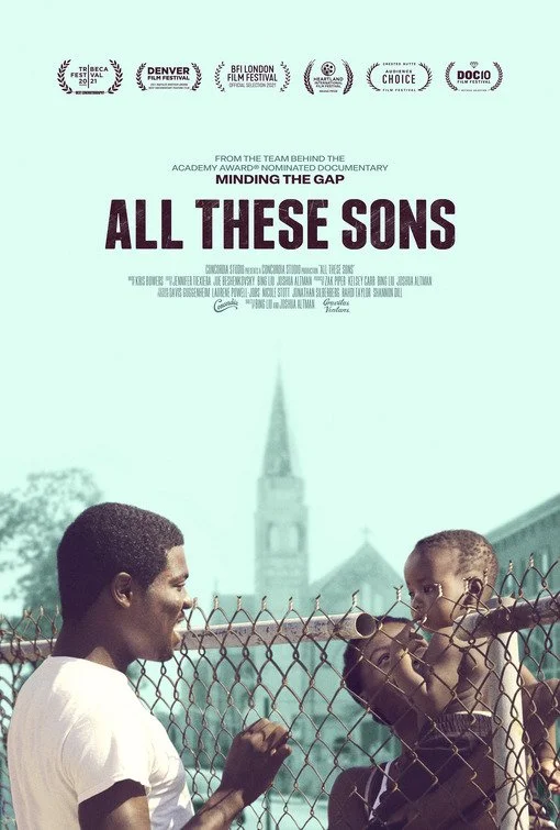 Poster for All These Sons: a young man smiles at a toddler, with a church steeple rising behind them in a pale, washed-out Chicago neighborhood. Above the title, it reads "From the team behind the Academy Award–nominated documentary Minding the Gap"