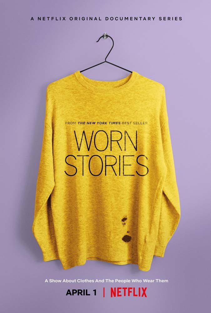 Poster for Worn Stories: a well-worn yellow sweater, with a small hole and stains near the hem, hangs on a hanger against lavender, the title printed across its chest. The tagline reads "A show about clothes and the people who wear them" — Netflix.