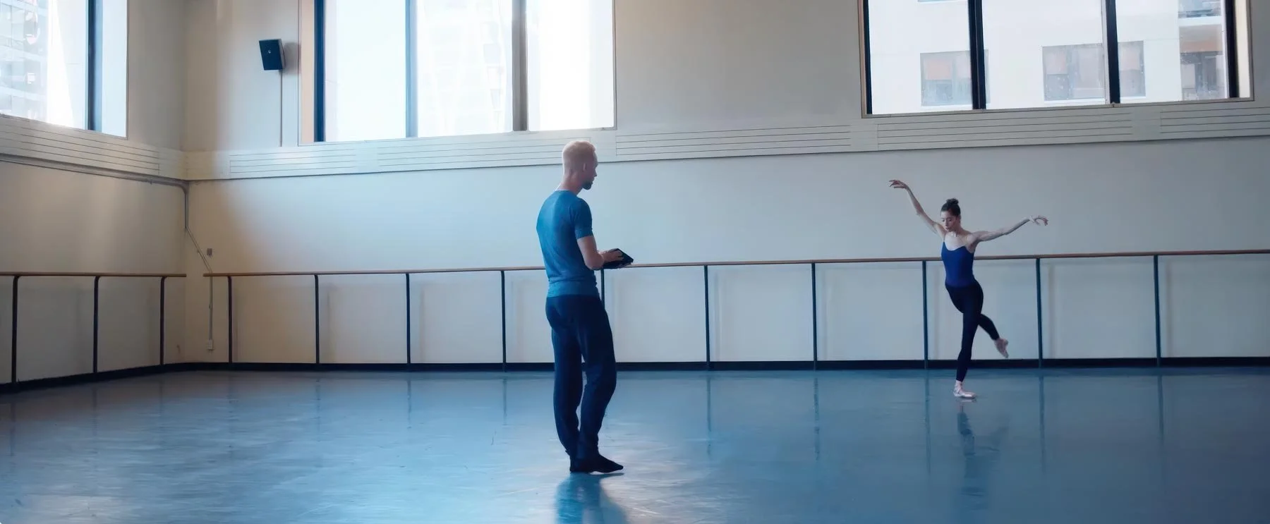 Pontus stands alone in the empty studio, sketchbook in hand — The Shimmering Asphalt, New York City Ballet.