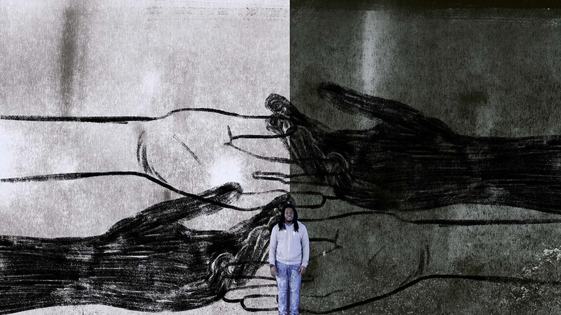 Darius Simpson stands before giant hand-drawn hands reaching toward each other — The Power of Proximity, Skoll World Forum.