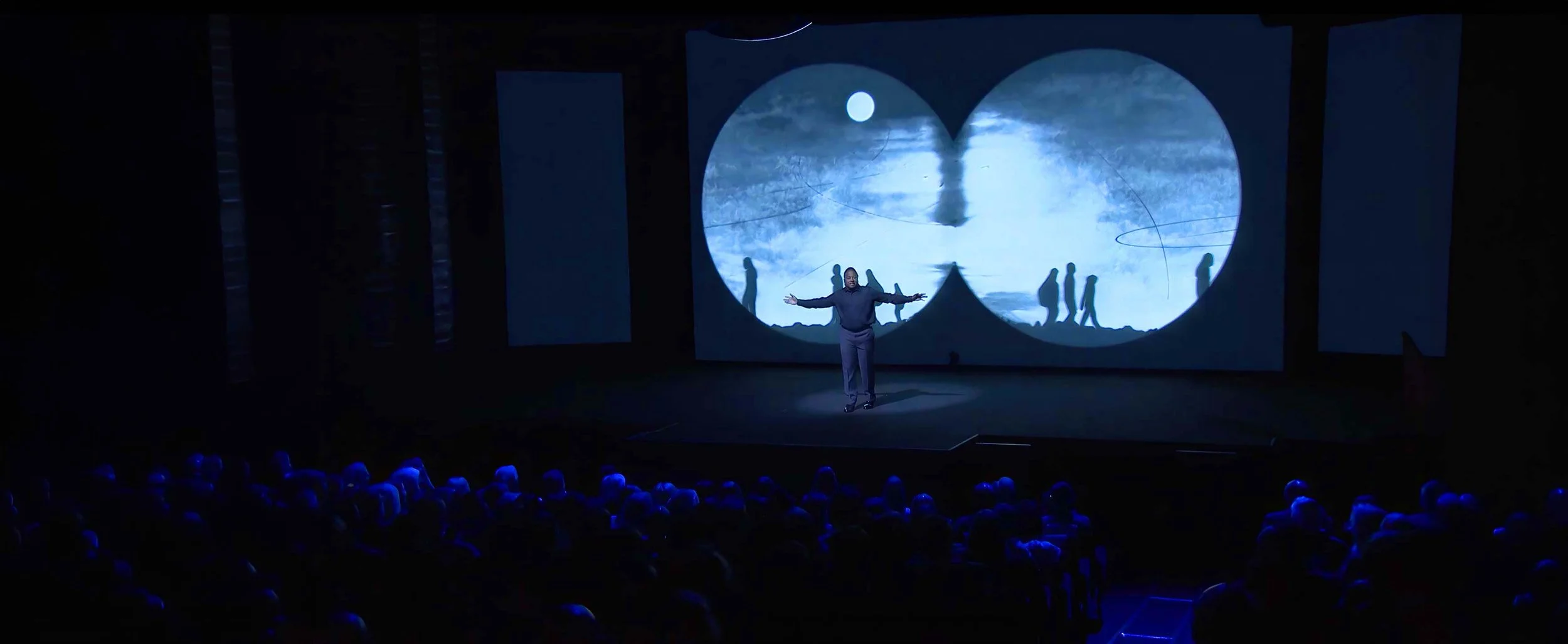 Darius Simpson performs in front of projected animation at the Skoll World Forum — The Power of Proximity.