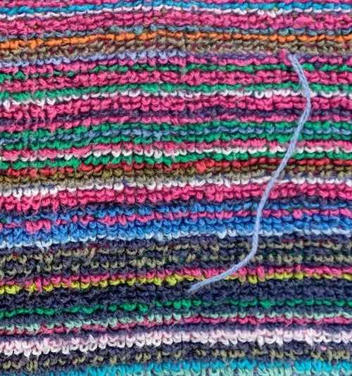 Fabric: a multicolored knit with a loose pale thread — Worn Stories, Netflix.