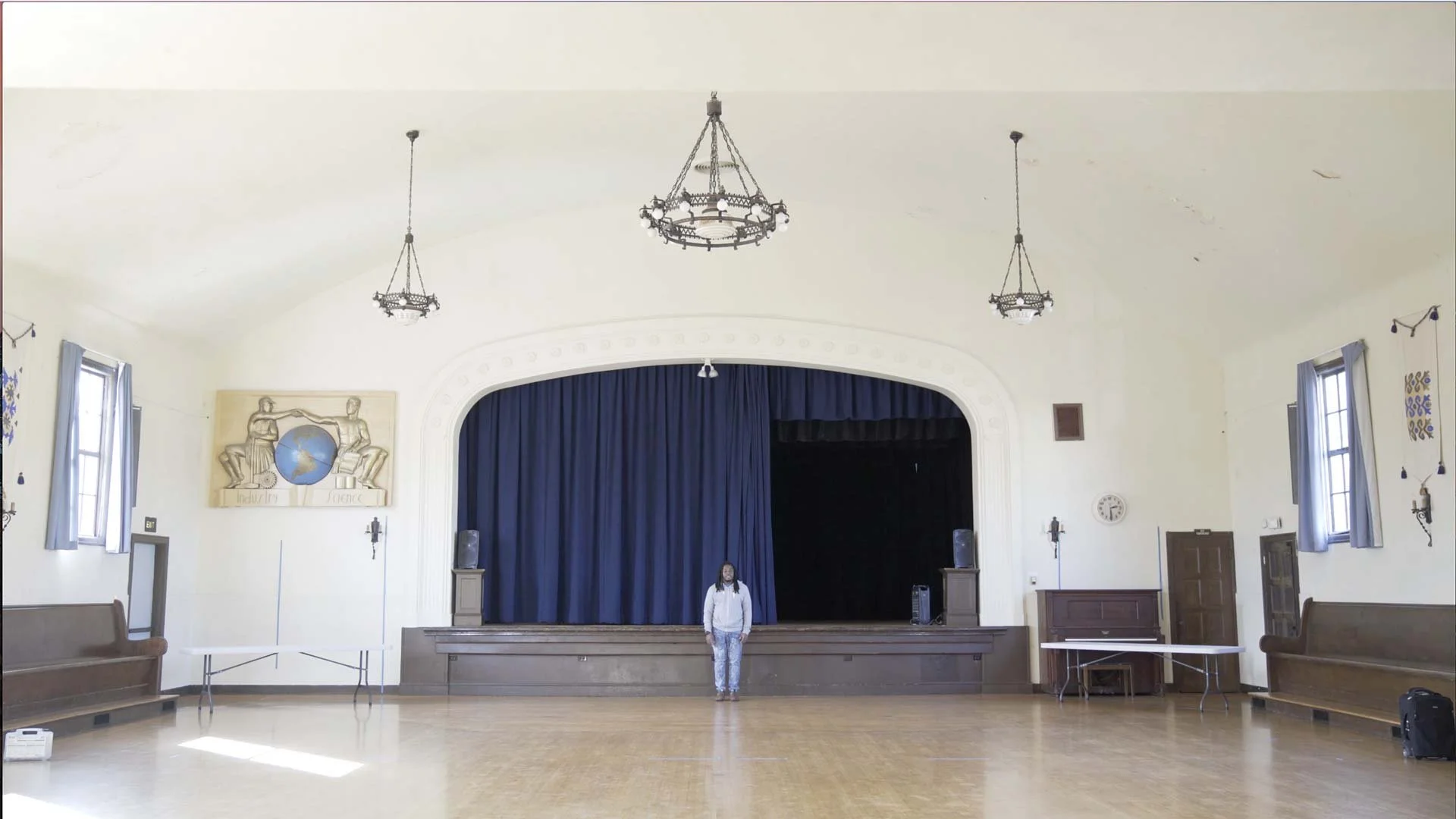 Darius Simpson rehearses alone in an empty hall, learning the timing of the piece before the performance in Oxford — The Power of Proximity, Skoll World Forum.