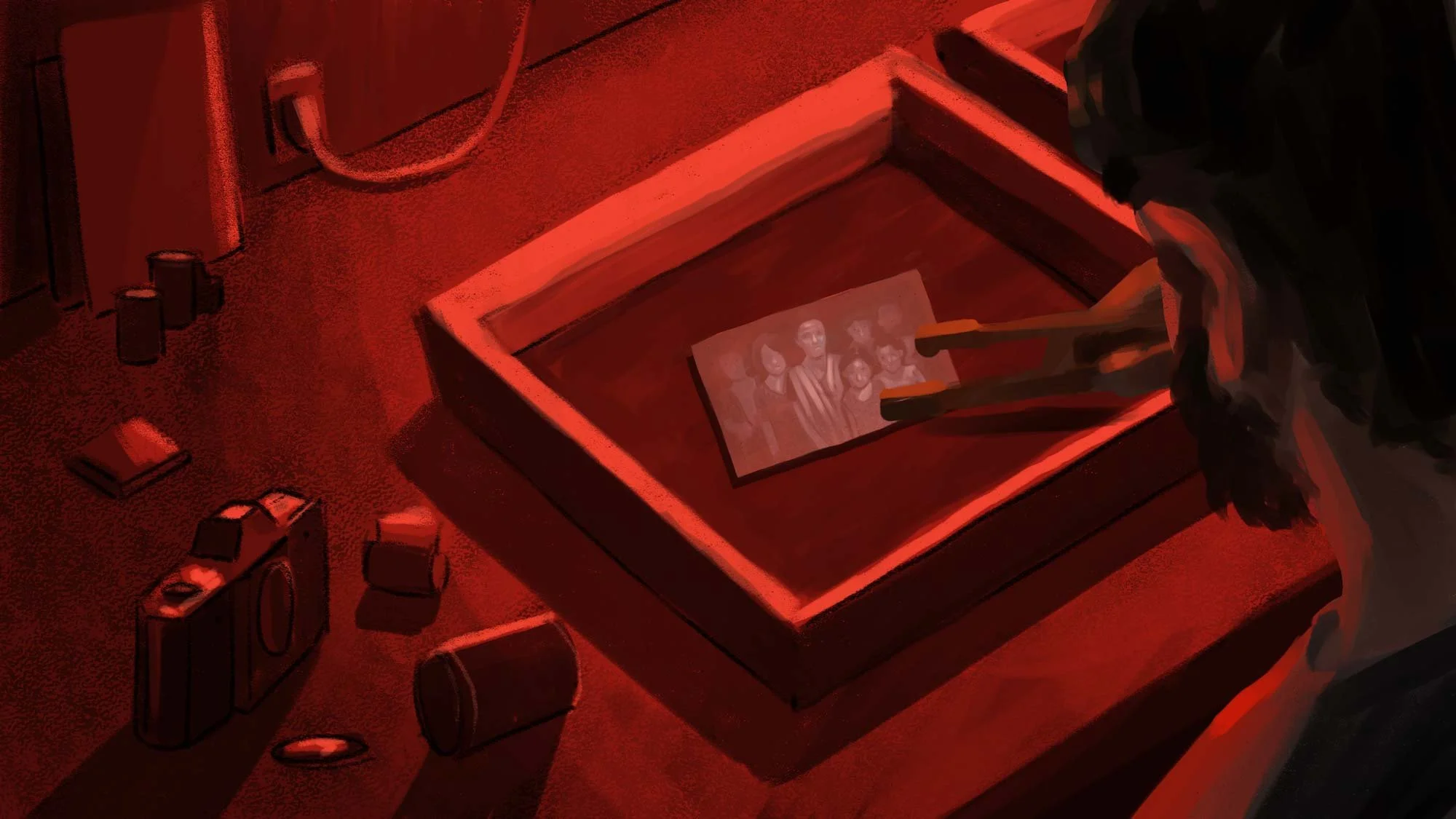 A photograph of the raid develops in a tray of chemicals under red light — The Price of Free.