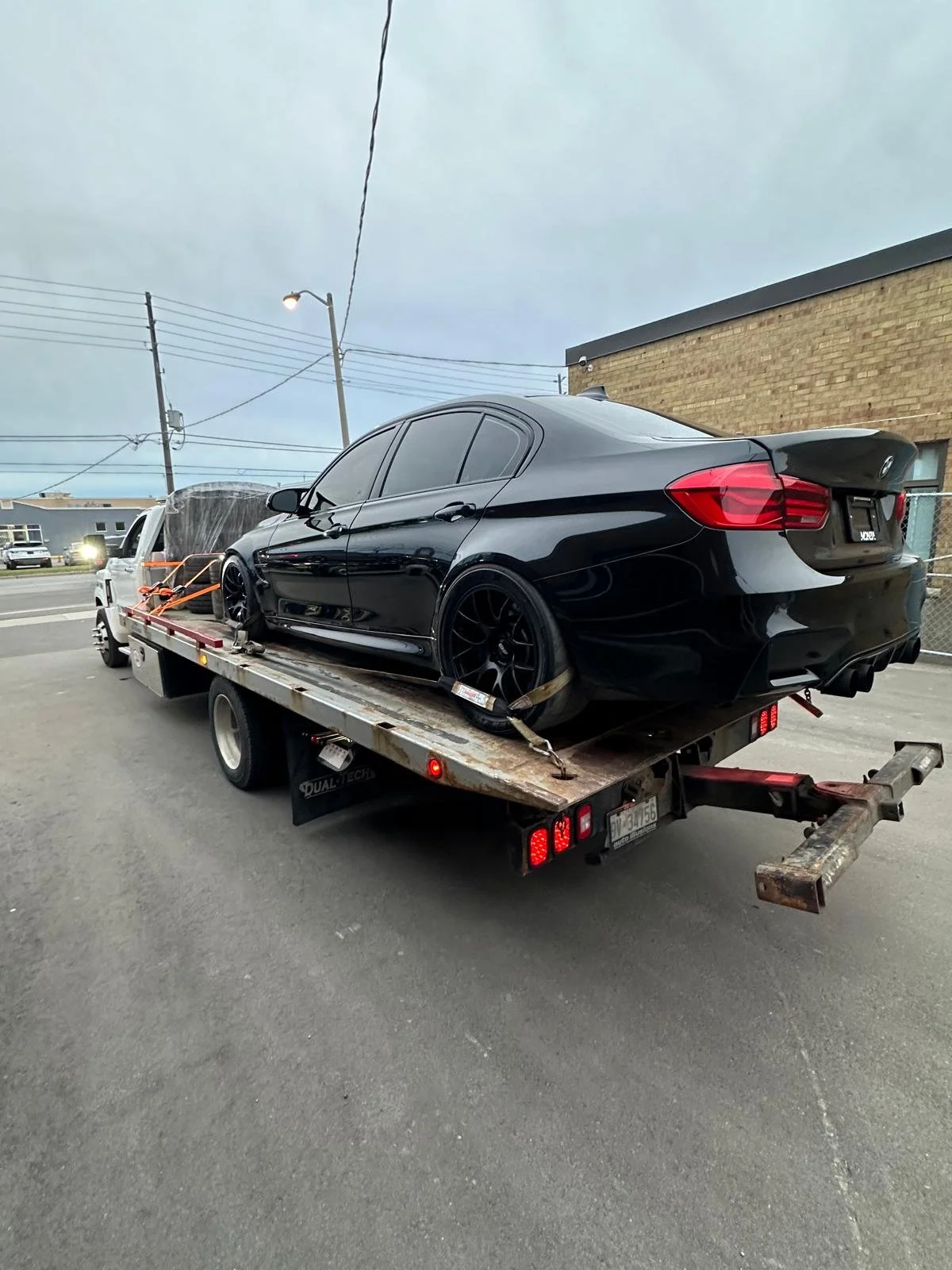 A special tow with 8x rims and tires, a Hood, car parts, and a very special BMW M3. We delivered this vehicle from Toronto to PEI