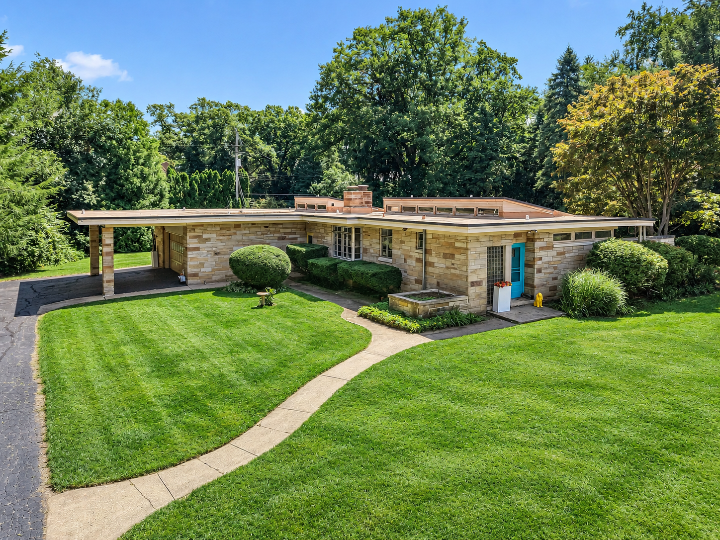 19 Greenacres Mid-century modern house with brick exterior, blue door, manicured lawn, mature trees on one acre.