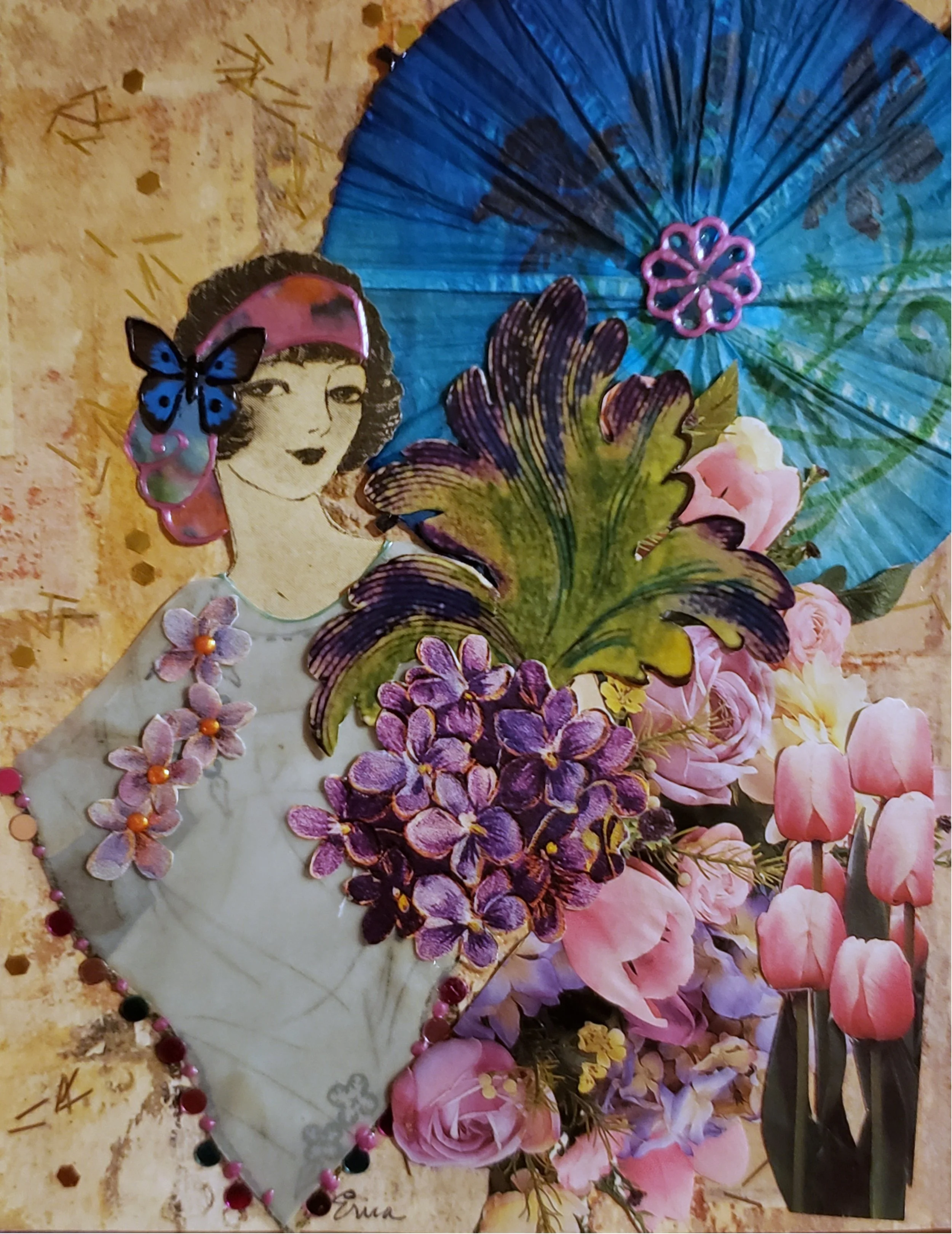 A decorated paper heart with pink and purple flowers, a young woman's face with a pink headscarf and butterfly hair accessory, a large blue paper parasol, pink roses, and other flowers arranged on a floral background.