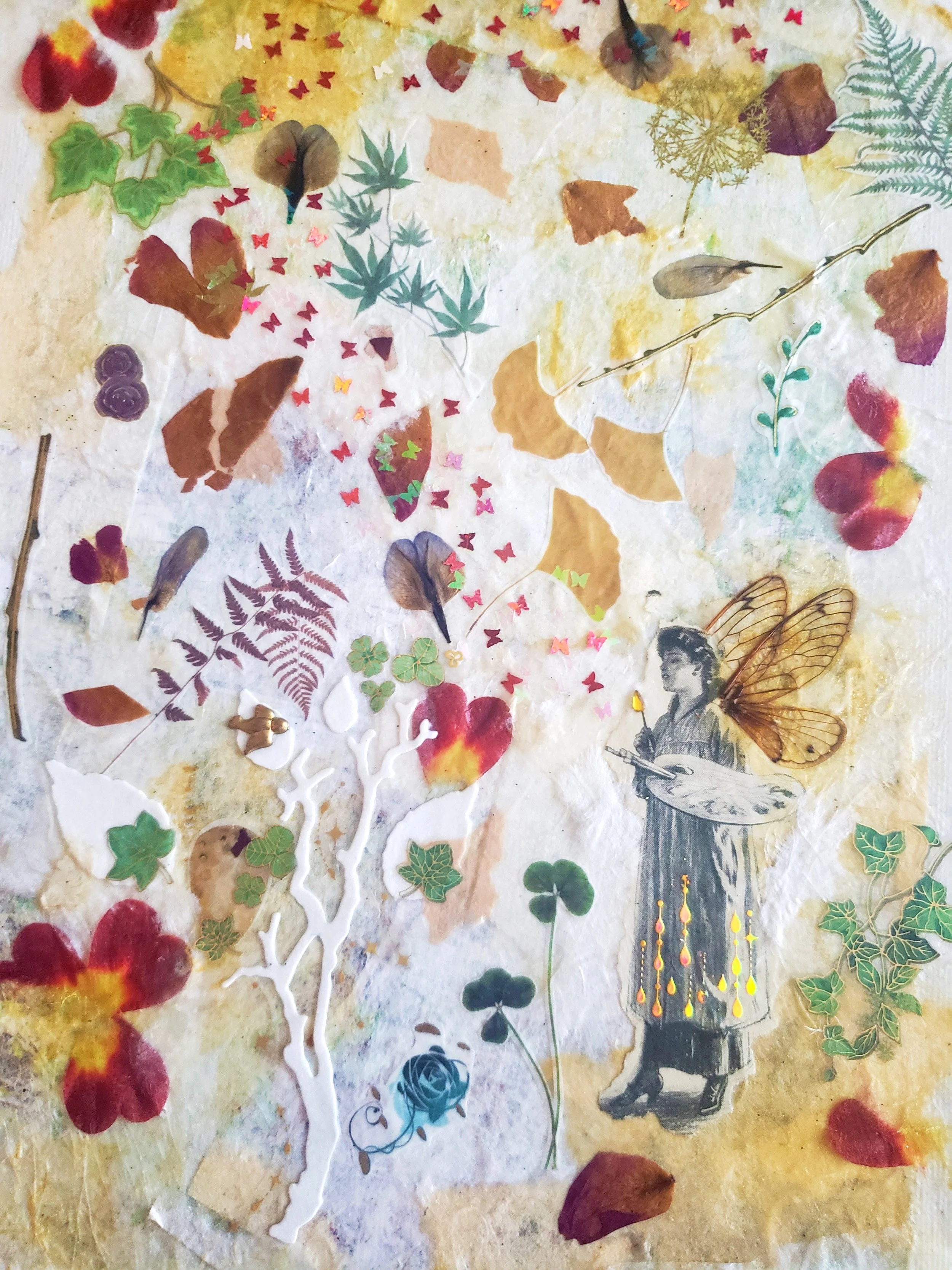 Mixed collage of dried leaves, paper cutouts, and decorative elements arranged on a textured background, including a vintage illustration of a person with butterfly wings, small colorful stickers, and ornate designs.
