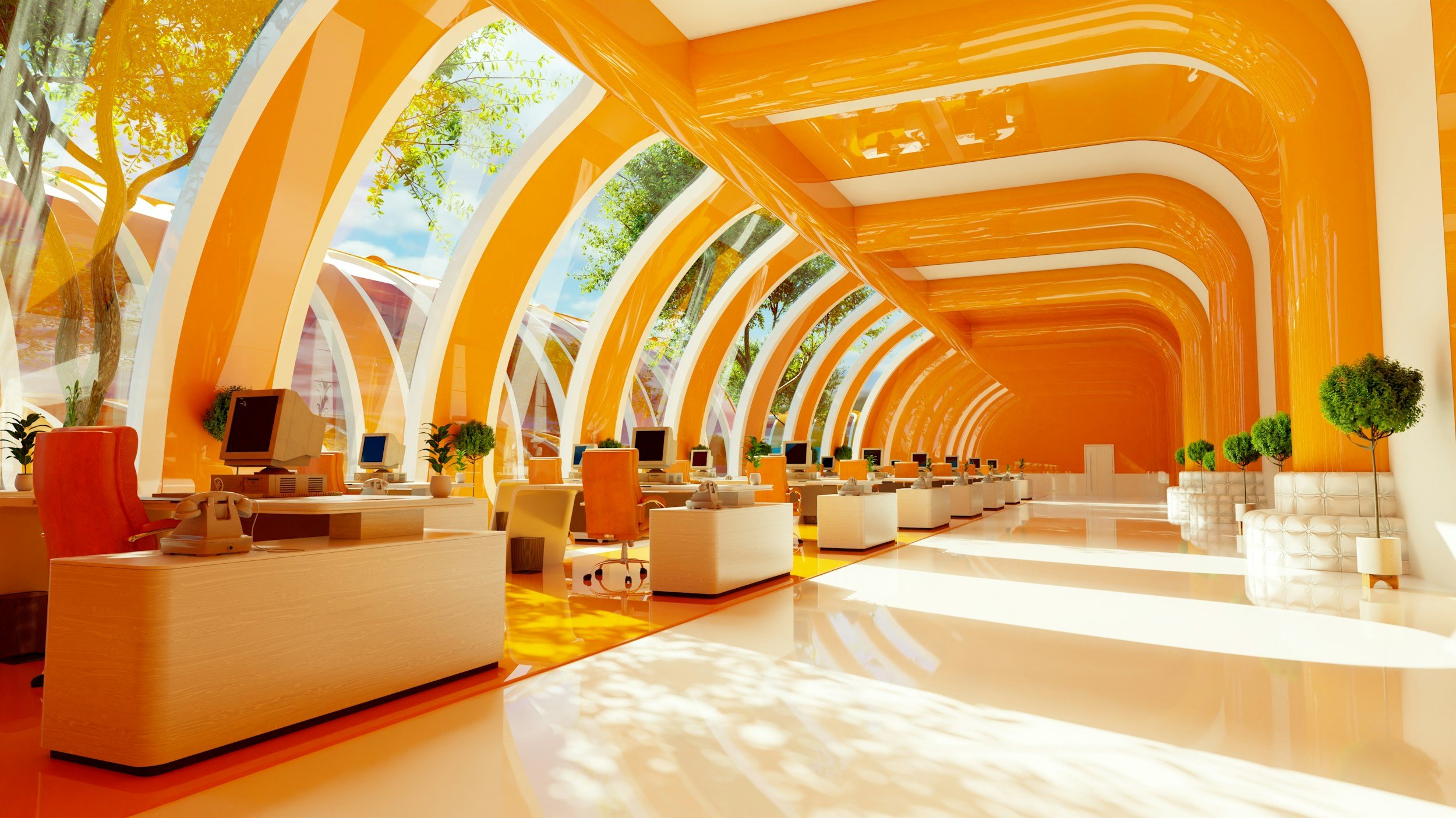 Bright modern office space with large arched windows, orange and cream color scheme, plants, and multiple workstations with computers.