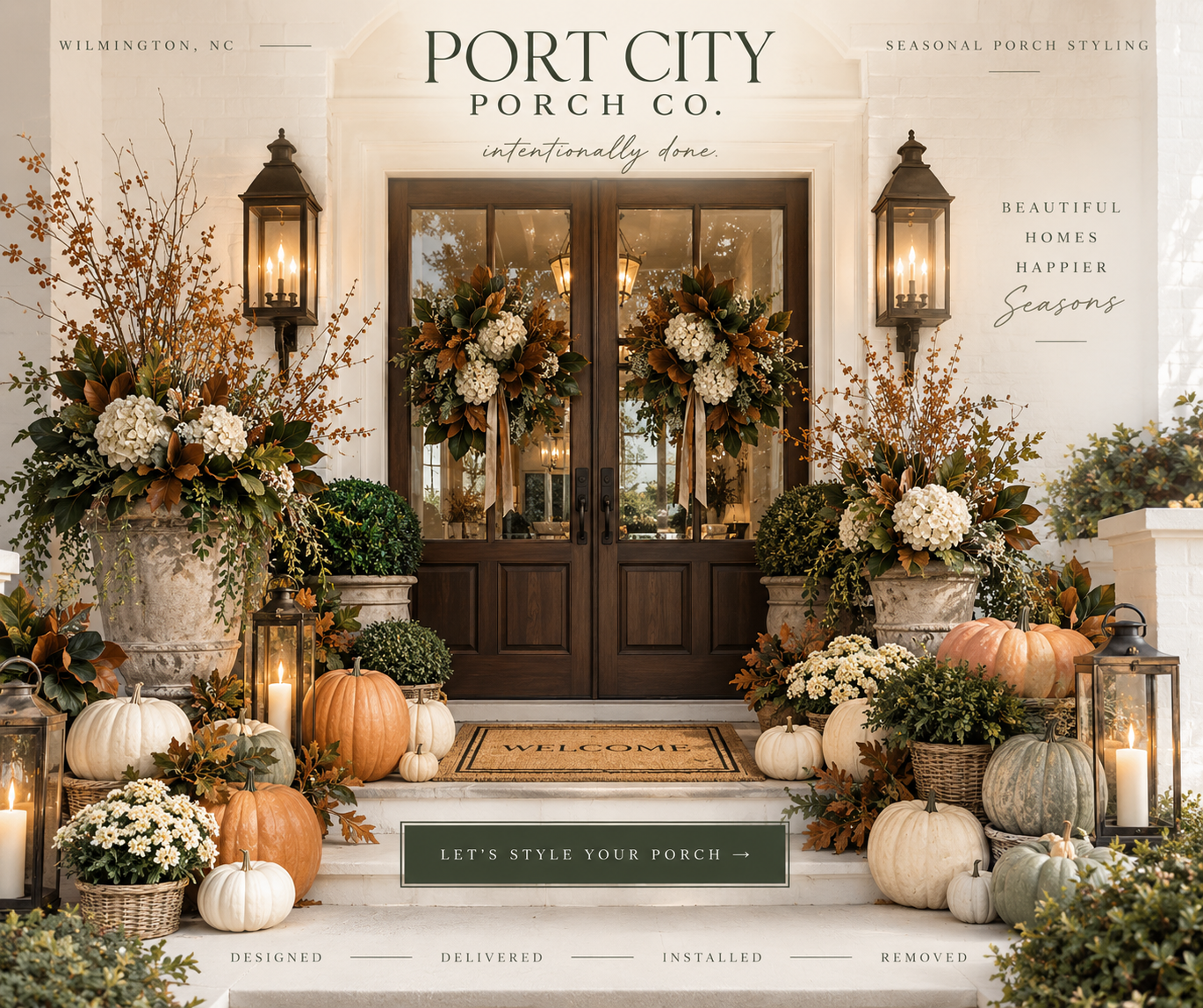 Decorated front porch with autumn pumpkins, white and orange flowers, candles in lanterns, and wreaths on glass double doors, with a welcome mat and signs for porch styling.