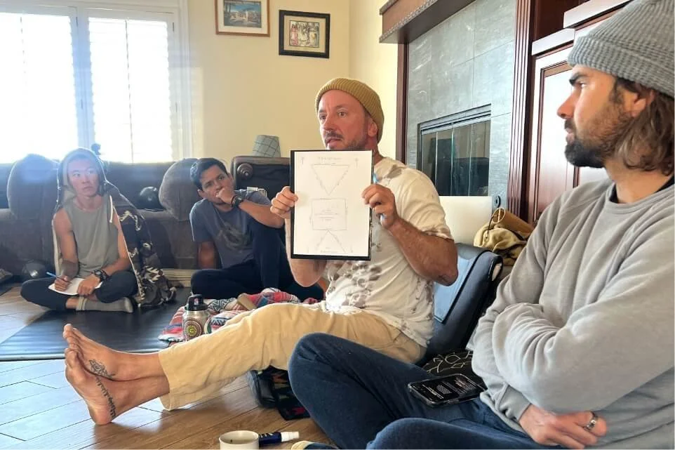 Instructor holding up notes while teaching a breathwork group