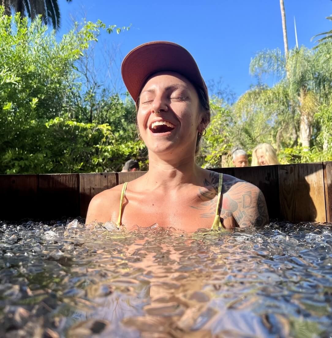 Woman laughing in an outdoor cold plunge
