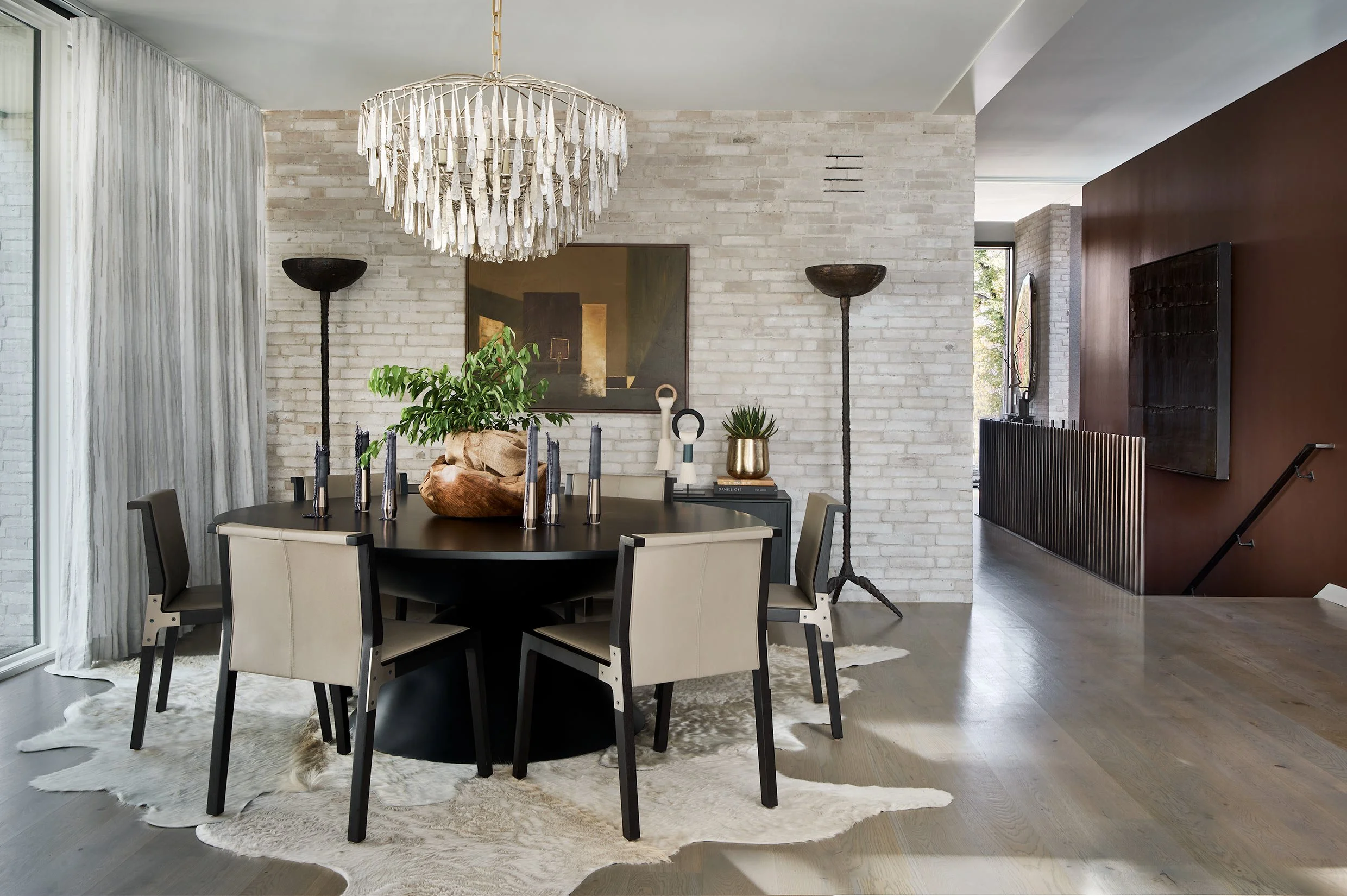 High-end residential interior design, neutrals, statement lighting, and a stylized round dining table. Designed by House of Mondi, dining room, Denver, Colorado, Chicago, Illinois.