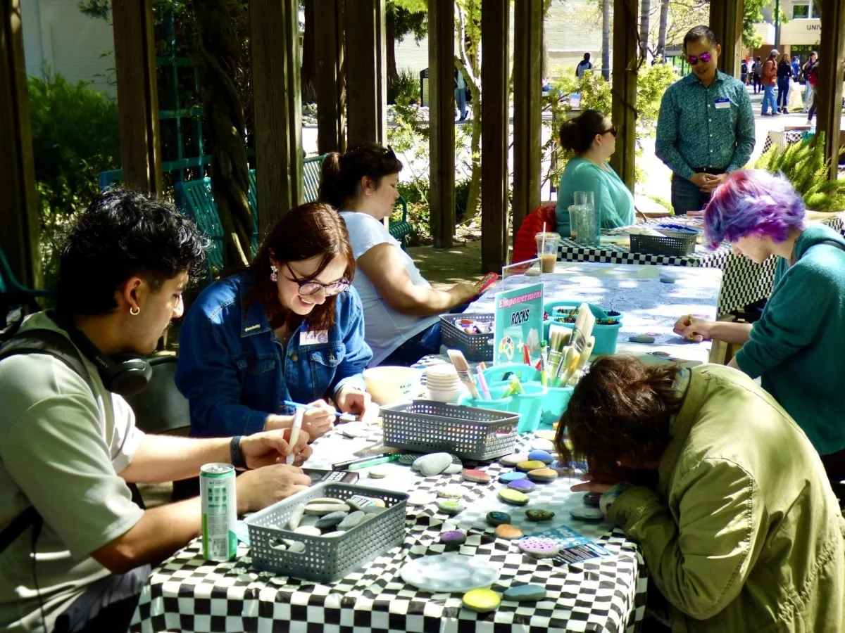  Students paint rocks at an arts and crafts booth at the Sexual Assault Awareness Day of Action fair Tuesday, April 2, 2024. Students were encouraged to decorate “empowerment rocks” in support of sexual assault awareness. (photo by   Isis Alvarez  ) 