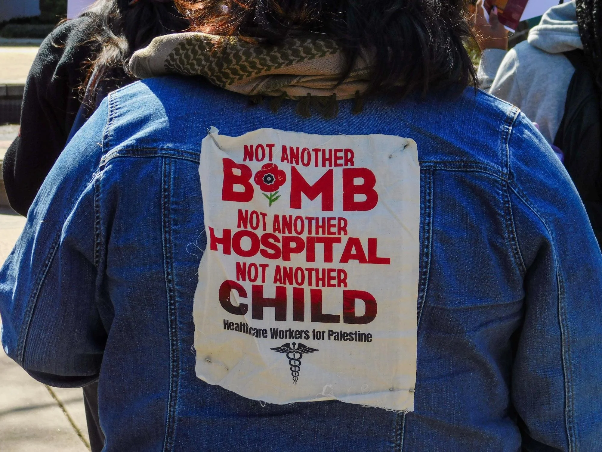  A protester wears a jacket in support of Palestine Tuesday, March 11, 2025. Conversations on immigration issues and the conflict in Gaza were spoken about during the protest. (photo by Kai Arellano) 