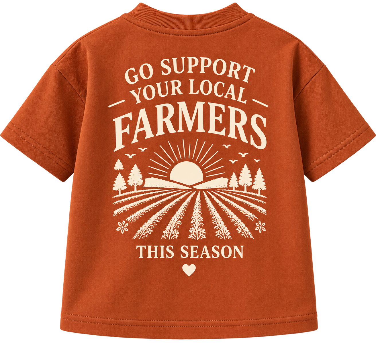 A burnt orange T-shirt with white text and illustrations supporting local farmers during the season. The design features a sunrise over a farm with rows of crops, trees, birds, and flowers.